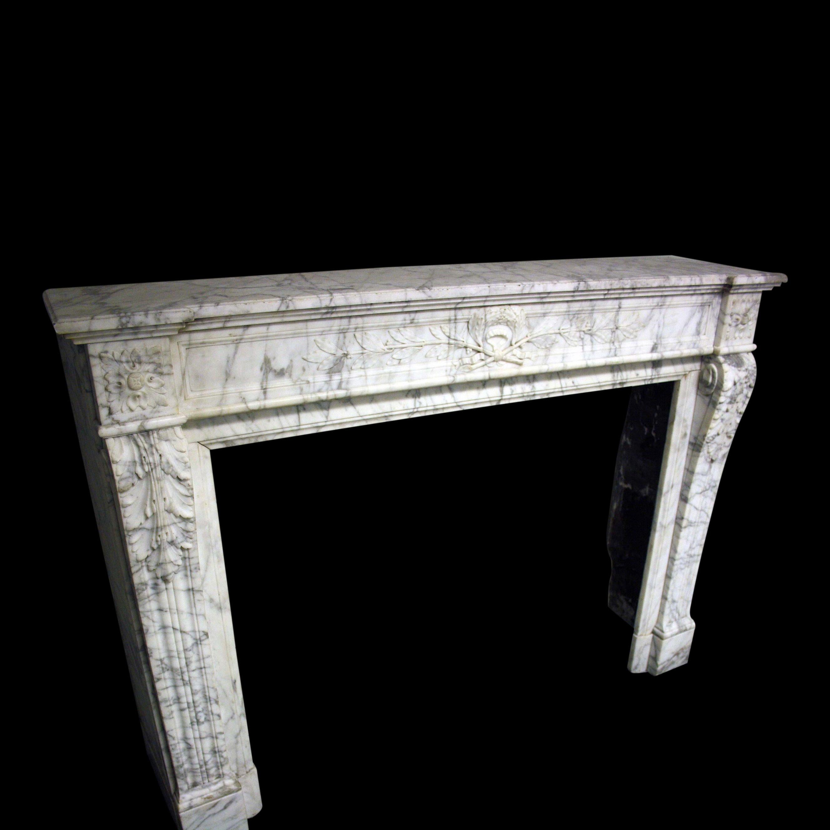 A French 19th century Carrara marble Chimneypiece in the Louis XVI manner

The Jambs formed of elongated moulded consoles with acanthus leaf terminals on plain block feet. The Frieze has a rectangular fielded panel with a central motif of
