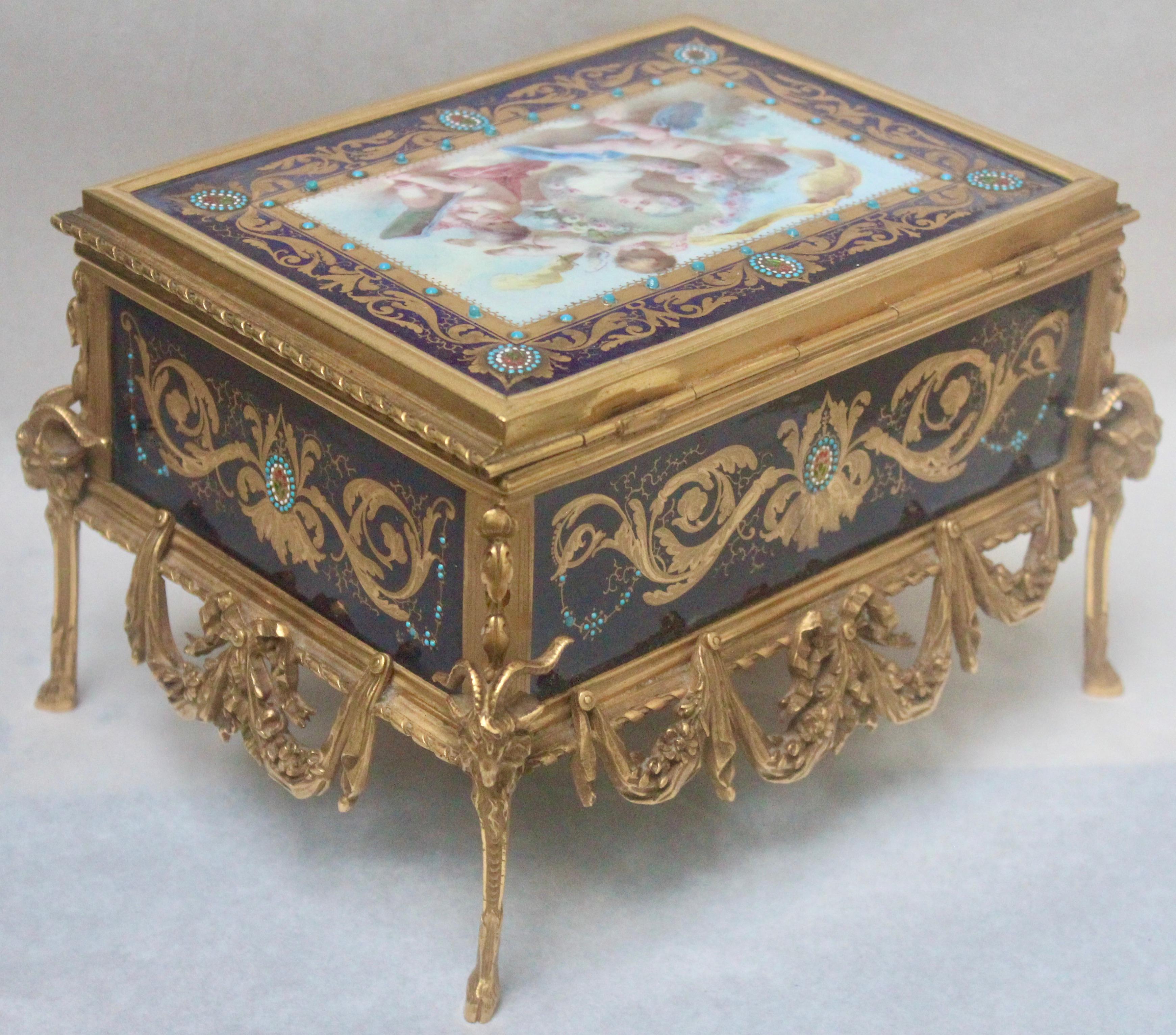 French 19th century hand painted enameled and ormolu-mounted jewelry casket
A rectangular ormolu-mounted and enameled plaques
With Blue Sèvres background and golden rinceaux and flowers heightened by blue, white, green and red Bresse