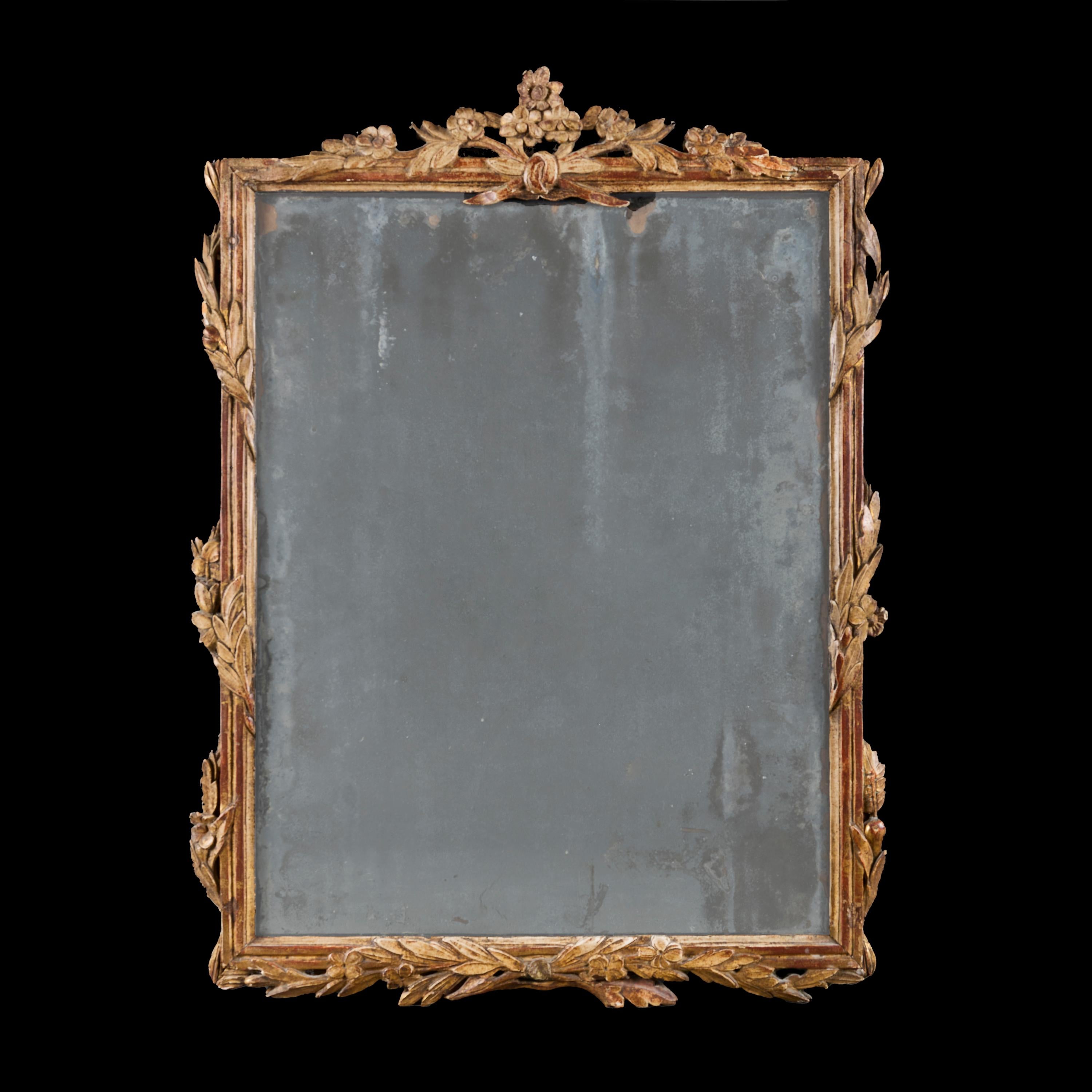 France, circa 1840.

A mid nineteenth century French giltwood mirror with foliate elements to the margins, with cornucopia of flowers to the cresting, with original mercury mirror plate. 

Height   87.00cm

Width    65.00cm