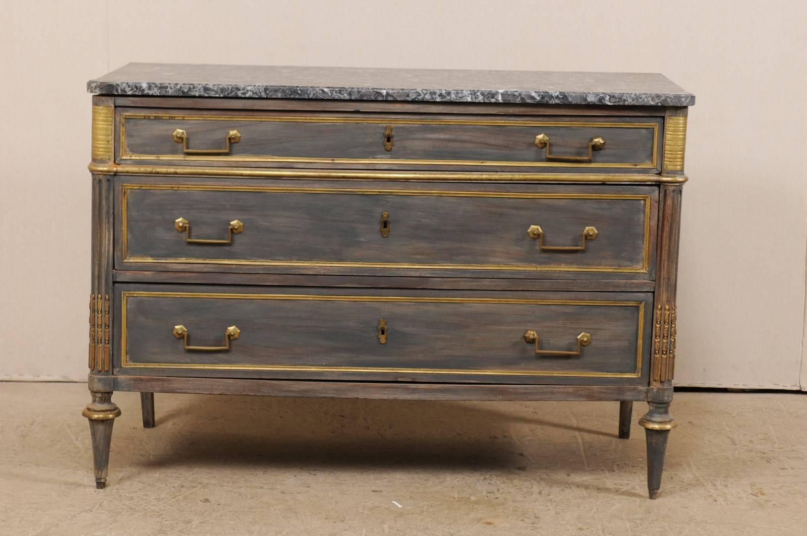 A French 19th century wood carved chest of drawers with marble top. This exquisite French antique chest features a marble top with rounded, cove-edges at both front corners, atop a neoclassical case with rounded side posts which are fluted and