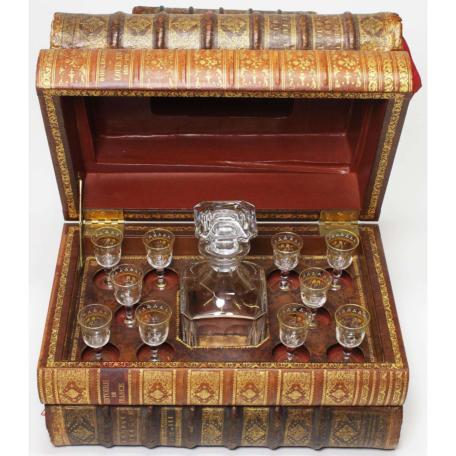 A fine French 19th century Tantalus Baccarat crystal decanter - liquor box - casket in the form of 'Stacked Leather Faux Books'. The five finely gilt-embossed leather-bound 'Period Style' books concealing an assembled set of ten later crystal and