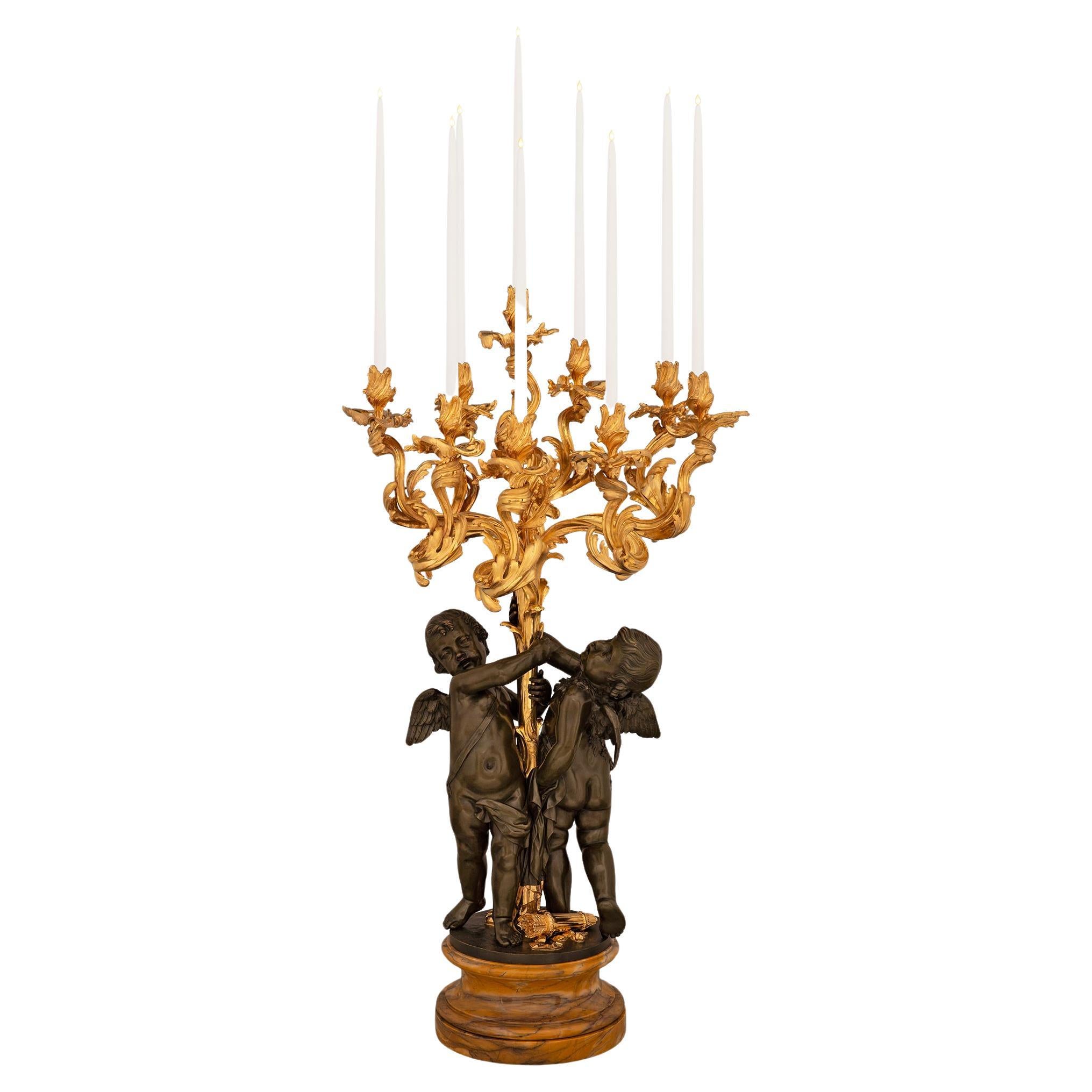 A French 19th century Louis XV st. Belle Époque period patinated candelabra