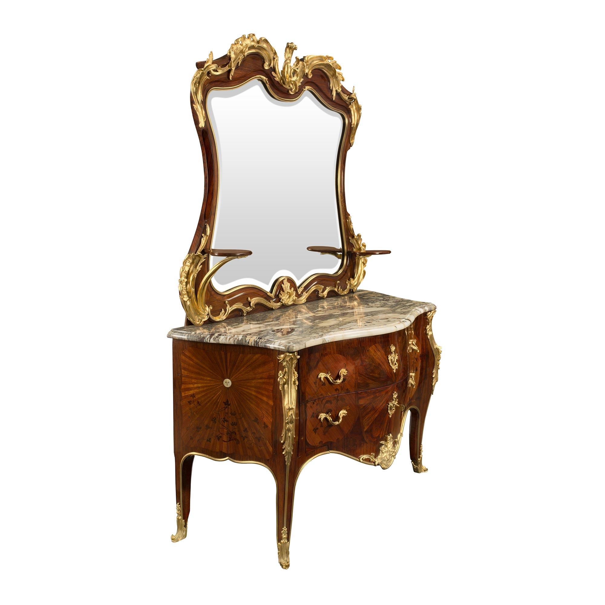 An extremely high quality French 19th century Louis XV style kingwood chest with its original matching mirror, attributed to Krieger. The impressive chest is raised by elegant cabriole legs with foliate wrap around ormolu sabots and an ormolu chute
