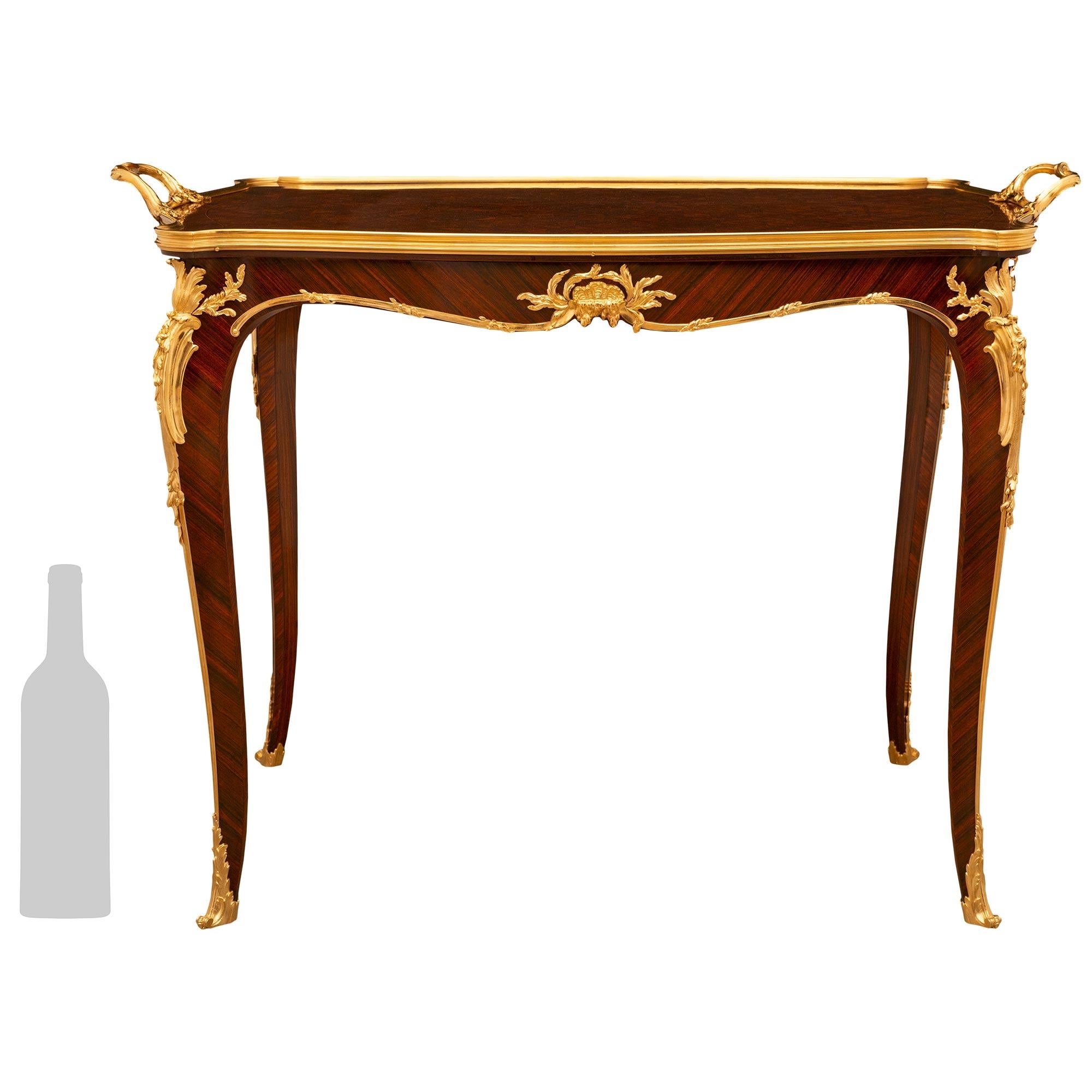 


A very high quality and most attractive French 19th century Louis XV st. Belle Epoque period Kingwood and Ormolu coffee table attributed to Francois Linke. The table is raised by elegant slender tapering cabriole legs decorated by a top foliate
