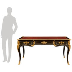 A French 19th century Louis XV st. Ebony, Brass and Ormolu desk