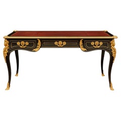 A French 19th century Louis XV st. Ebony, Brass and Ormolu desk
