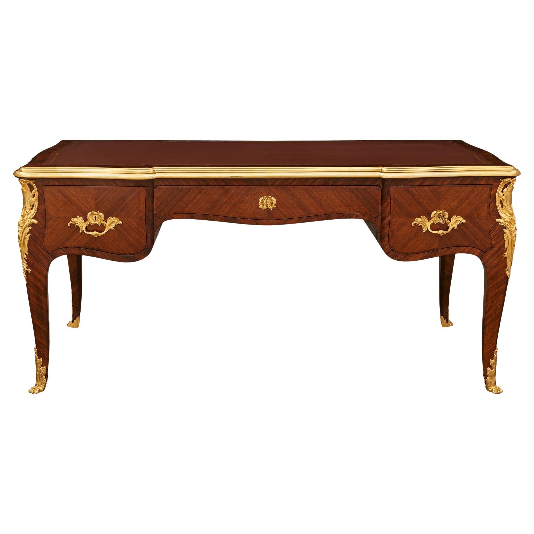 A French 19th century Louis XV st. Tulipwood and Ormolu desk