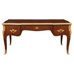 A French 19th century Louis XV st. Tulipwood and Ormolu desk