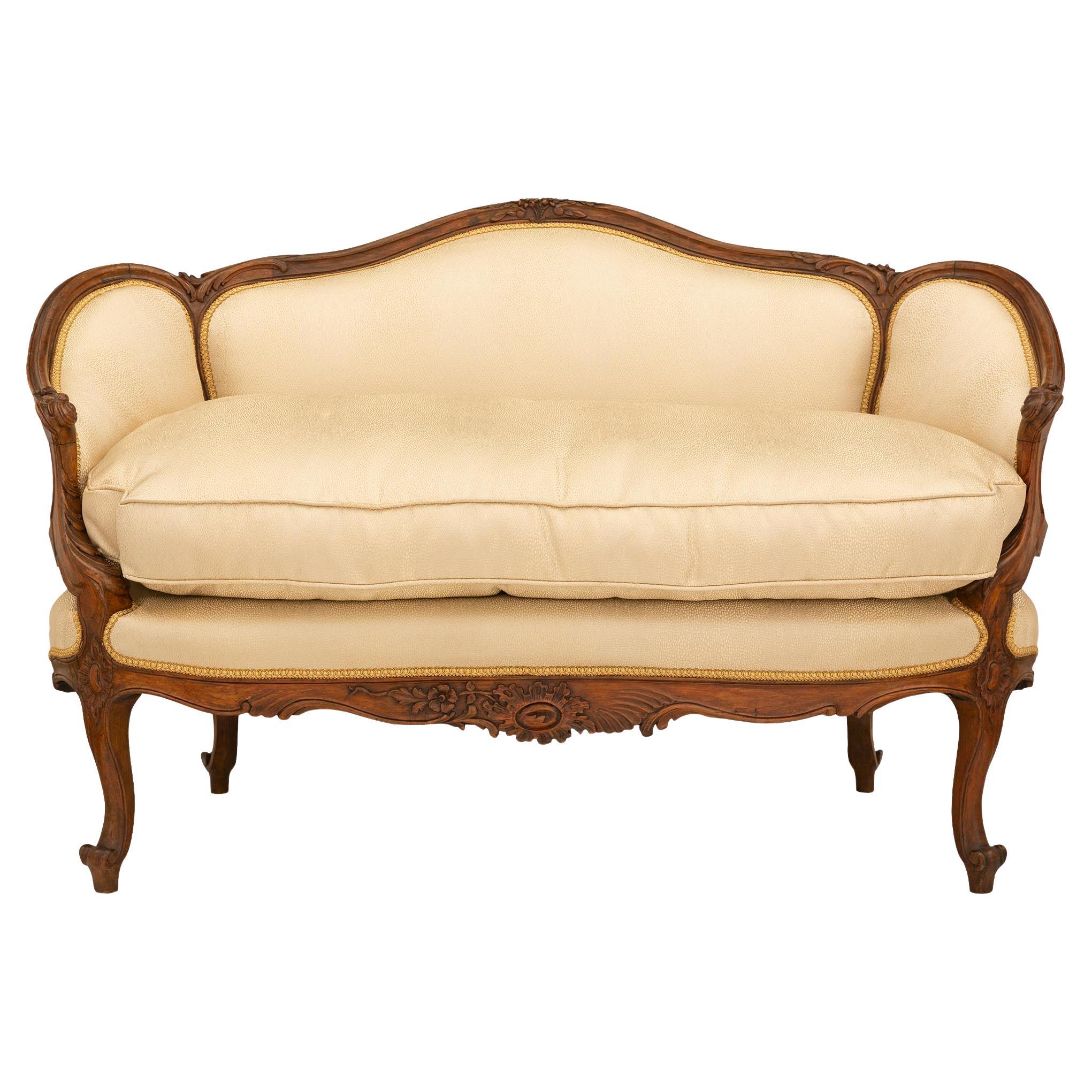 A French 19th century Louis XV st. walnut settee