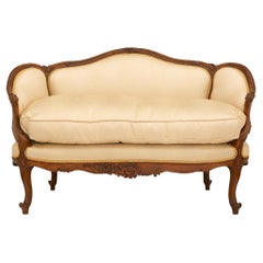 A French 19th century Louis XV st. walnut settee