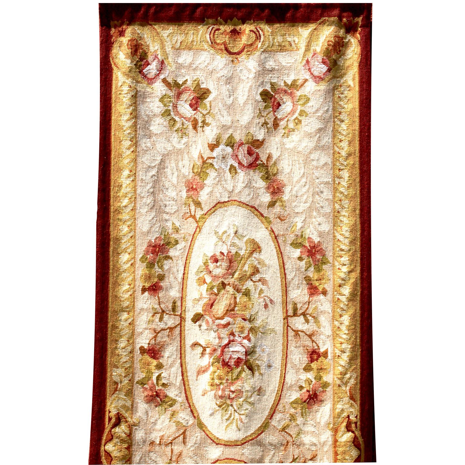 A fine French 19th century Louis XV style Aubusson tapestry panel. The elongated tapestry fragment with a floral design of rose bouquets and strands, with two oval panels centered by floral bouquets and an acanthus and floral border. Circa: