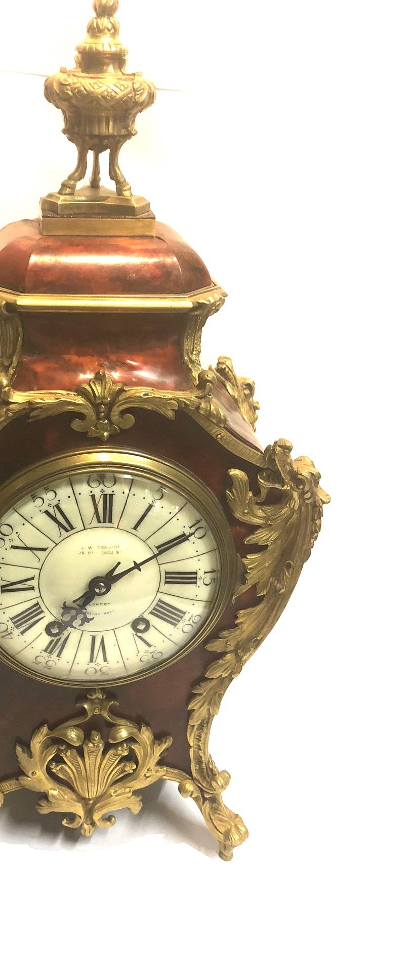 The French red tortoiseshell case with urn finial, foliated bronze mounts with dragon heads to the shoulder and lower leaf molded crest, the English dial stamped 'J.W. Benson 25 Old Bond Street London'.

Established in 1874, J.W. Benson clock and