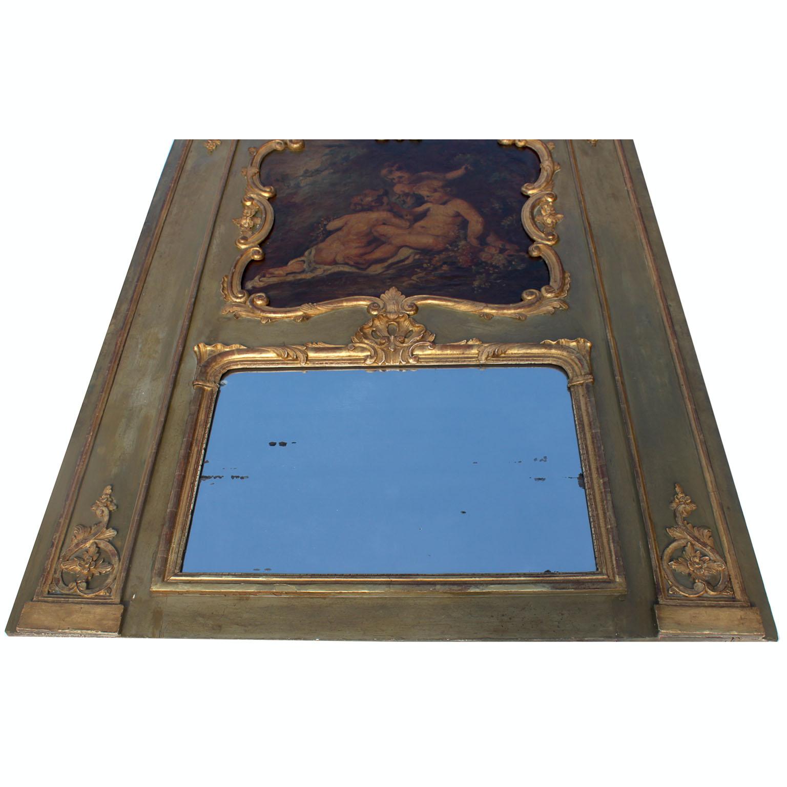 A French 19th Century Louis XV Style Parcel Gilt-Wood Carved Wood Trumeau Mirror. The Rectangular shaped frame crowned with a whimsical oil on canvas depicting three children (Putto) seated amongst flower and trees, with a parcel-gilt carved-wood
