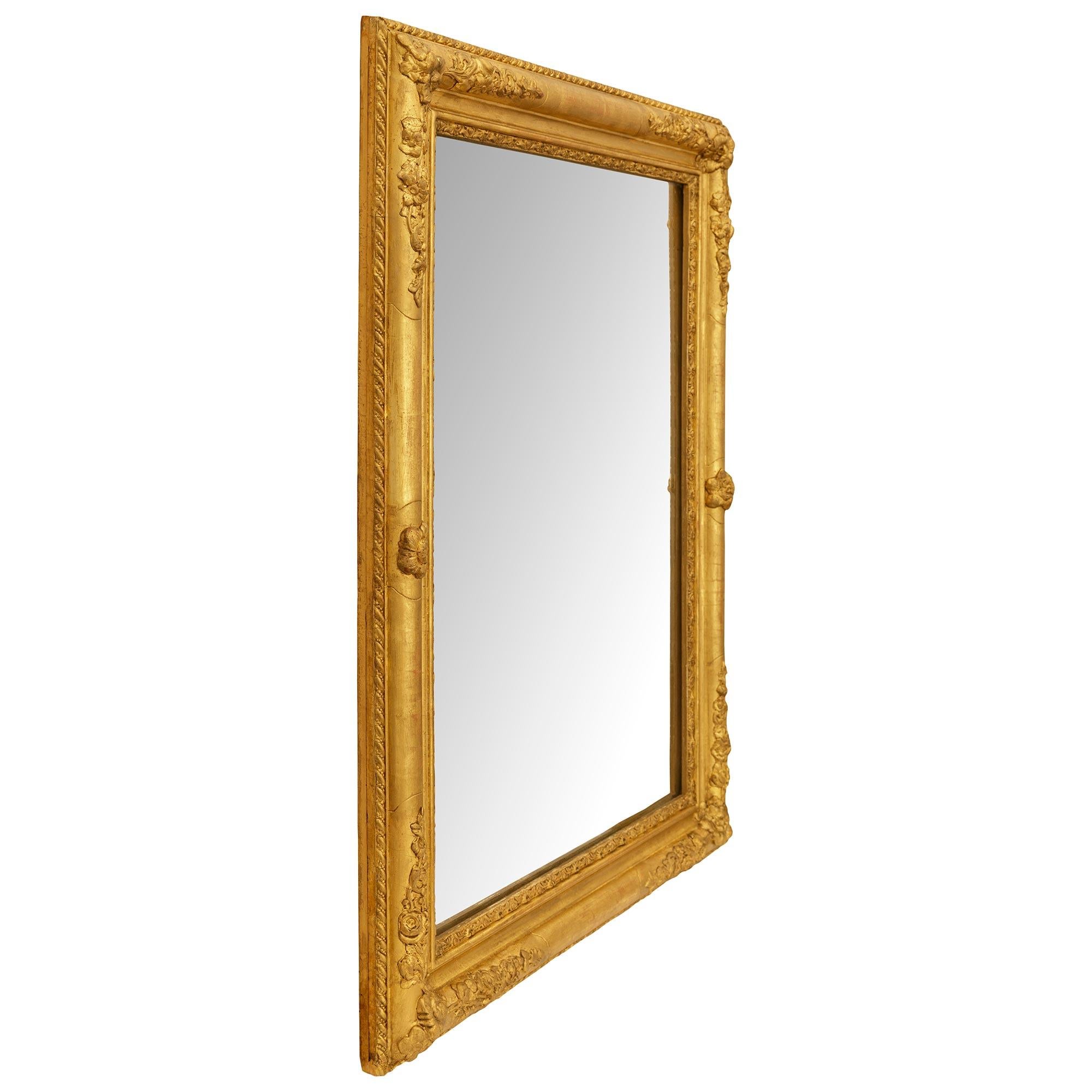 Louis XVI A French 19th century Louis XV/XVI st. Giltwood mirror For Sale