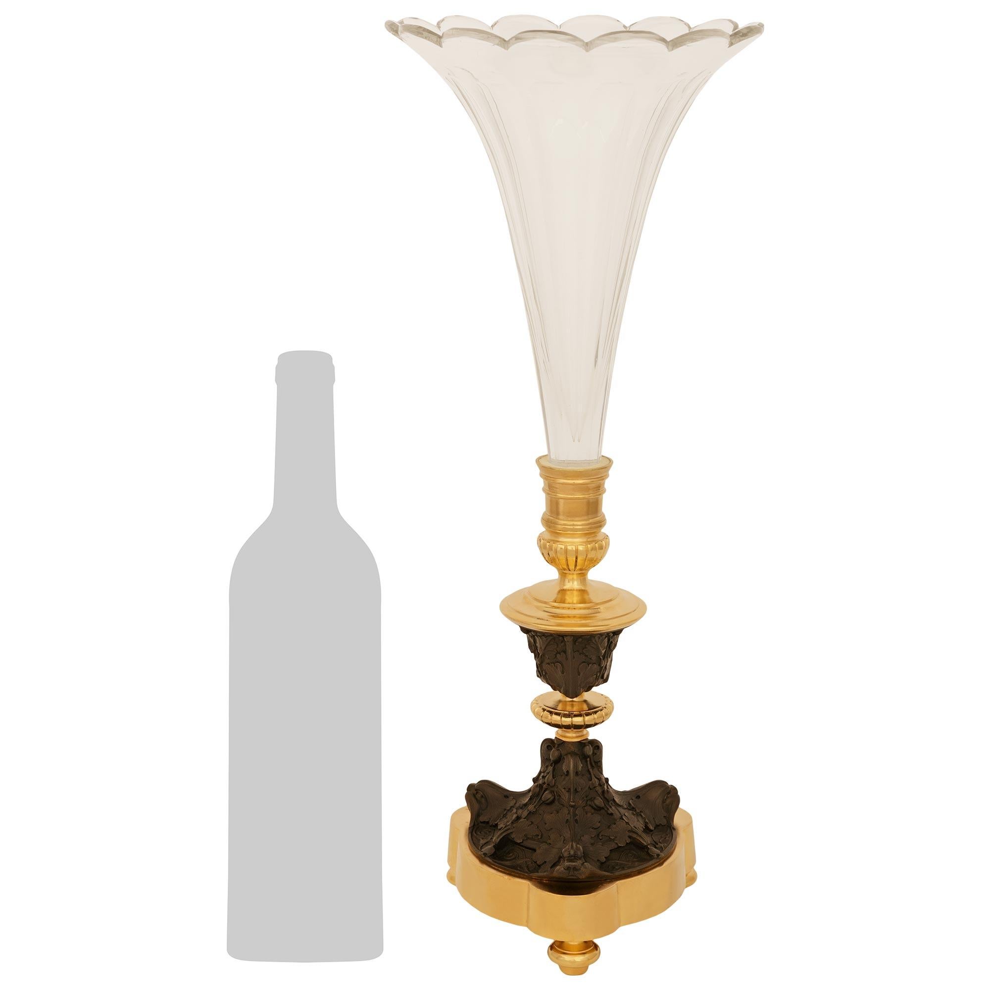 Un affascinante vaso francese di alta qualità del XIX secolo in bronzo patinato, Ormolu e cristallo Baccarat. Questo splendido vaso è sollevato da tre piedi a forma di topie in Ormolu che sorreggono una base triangolare su cui poggia un'affascinante