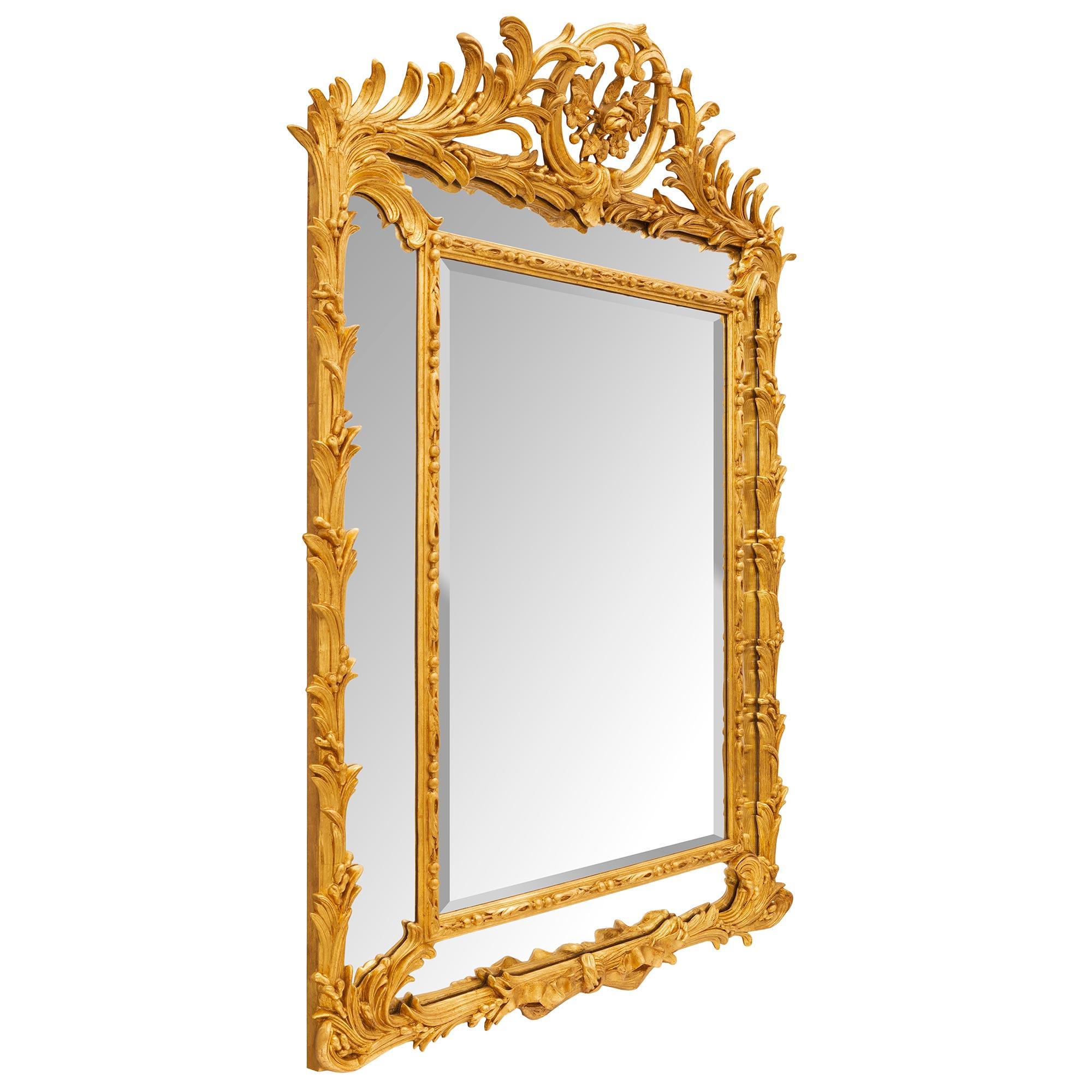 An exceptional French 19th century Louis XVI st. double framed giltwood mirror. The mirror retains all of its original mirror plates throughout with the central beveled mirror plate framed within an elegant beaded and laurel leaf border. Stunning