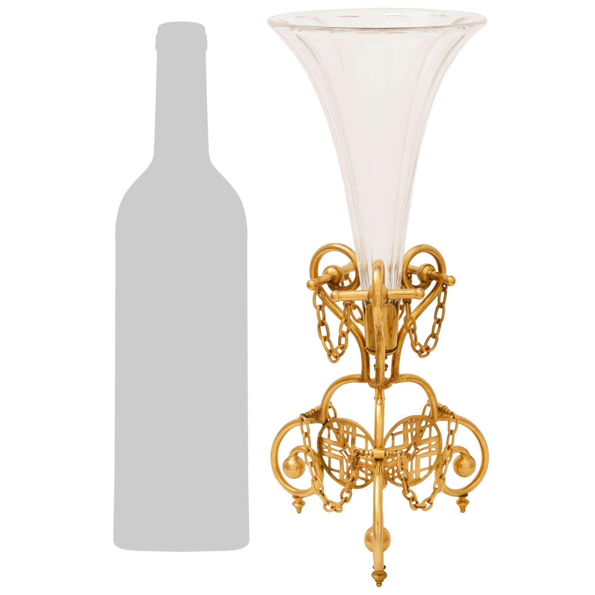 An elegant and most unique French 19th century Louis XVI st. Ormolu and Baccarat Crystal vase. This stunning vase is raised on a tripod shaped Ormolu base has scrolled legs and Ormolu toupie shaped feet. At the center are three most decorative