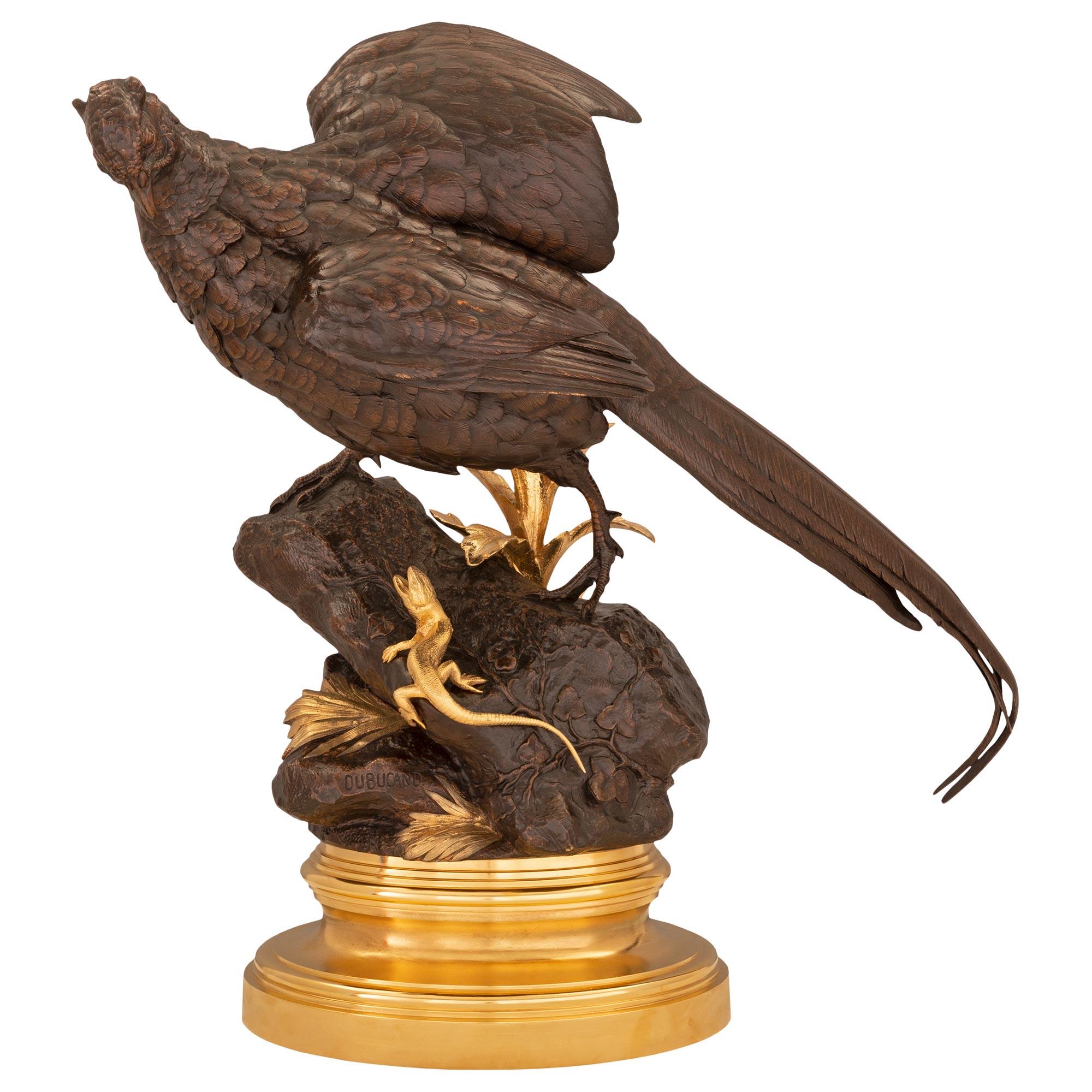 A striking and high quality French 19th century Louis XVI st. ormolu and patinated bronze statue of a pheasant, signed Dubucand. The impressive statue is raised by a circular mottled stepped ormolu base below the wonderfully executed ground like