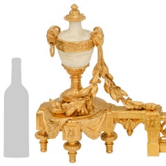 A French 19th century Louis XVI st. Ormolu and Onyx andiron set