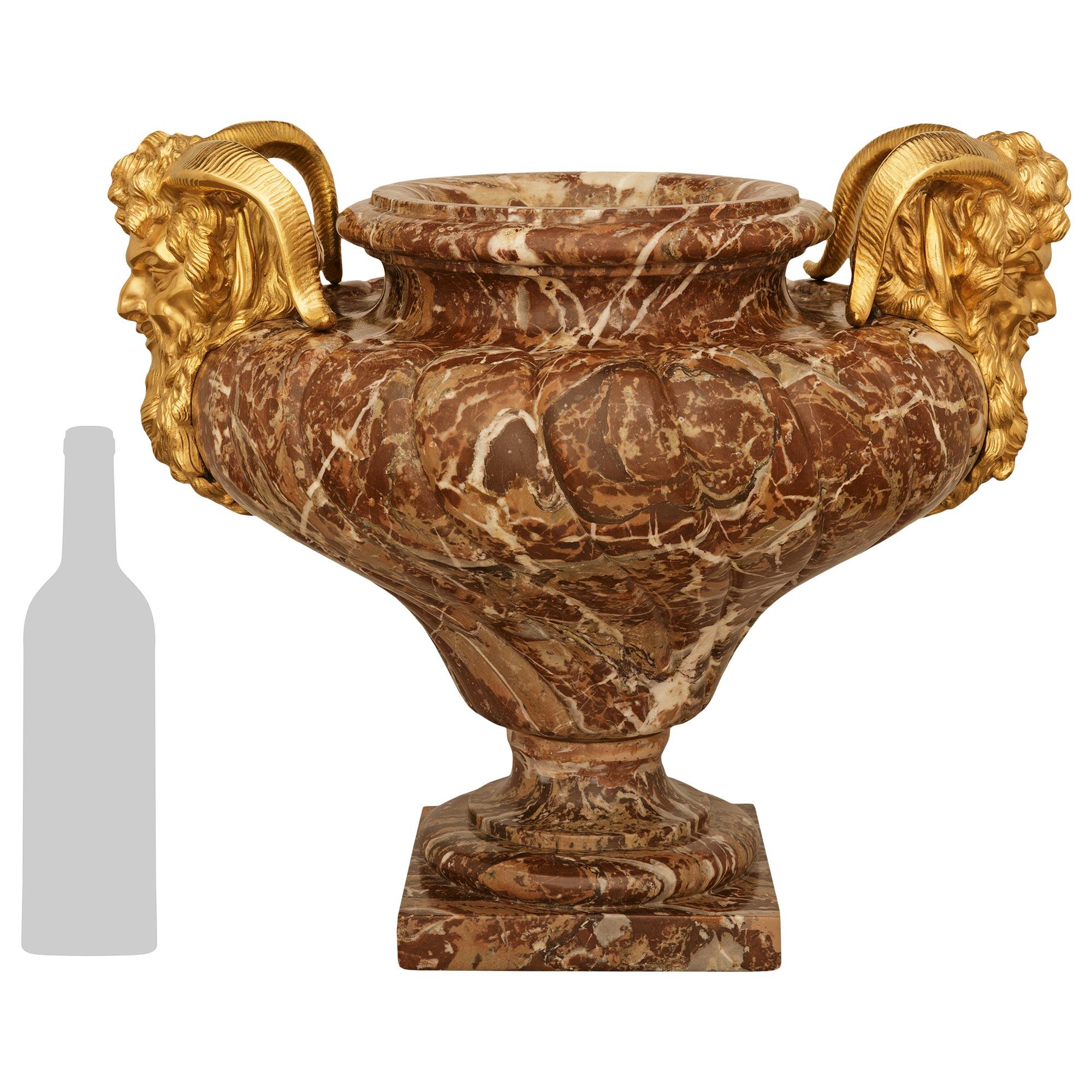 A sensational and most impressive French 19th century Louis XVI st. Rouge Royale marble and Ormolu urn/planter. This exceptional urn is raised on a solid Rouge Royale marble plinth below a circular mottle socle and Ormolu band. The marble body