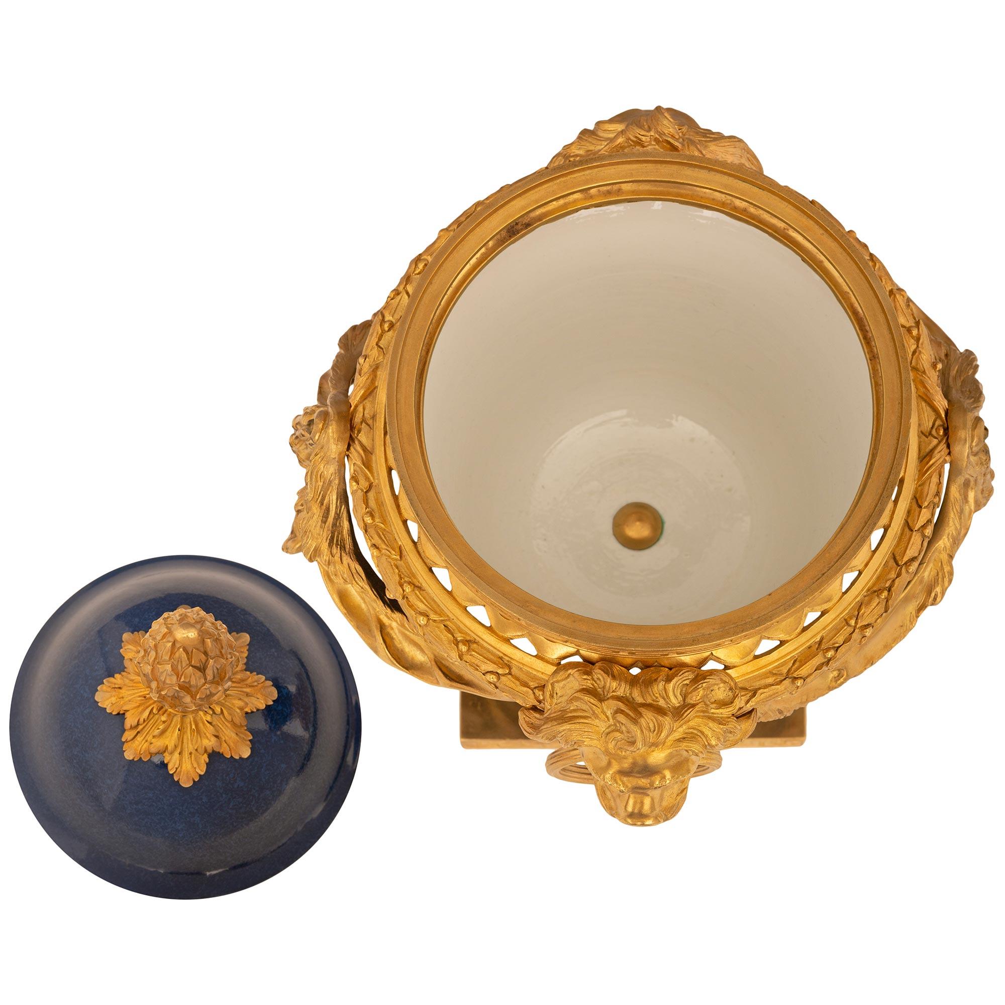 A sensational and most attractive pair of French mid-19th century Louis XVI st. cobalt blue Sèvres porcelain and ormolu pot pourri urns. The pair are raised by a square ormolu base with a Greek key design on the sides. Above is the circular support