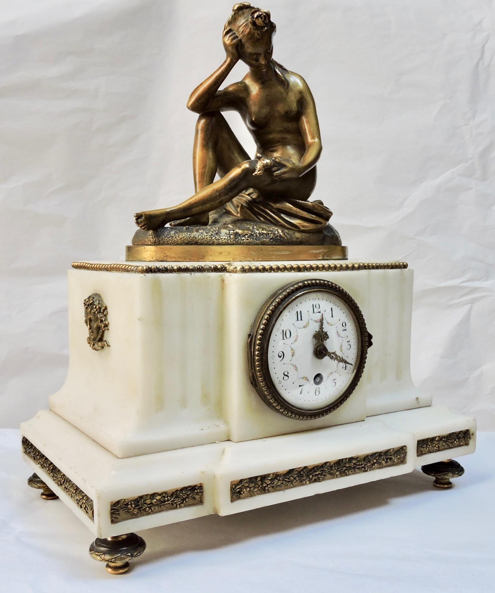 A French 19th century marble and ormolu clock
 The Carrare marble case surmounted by a bronze sculpture after Etienne Maurice Falconnet, 