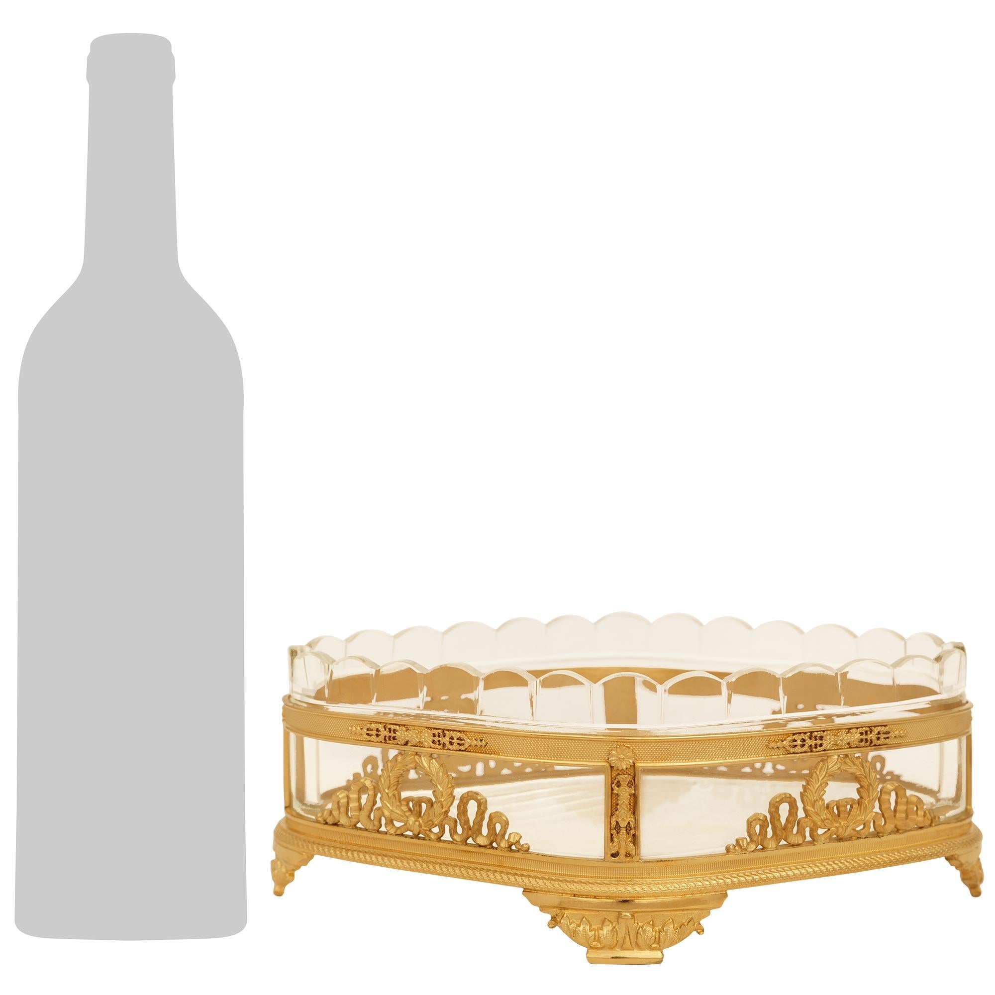 An elegant and high quality French 19th century Neo-Classical st. Ormolu and Baccarat Crystal centerpiece. This charming diamond shaped centerpiece is raised on four acanthus leaf decorated feet below the straight frieze with a twisted rope design