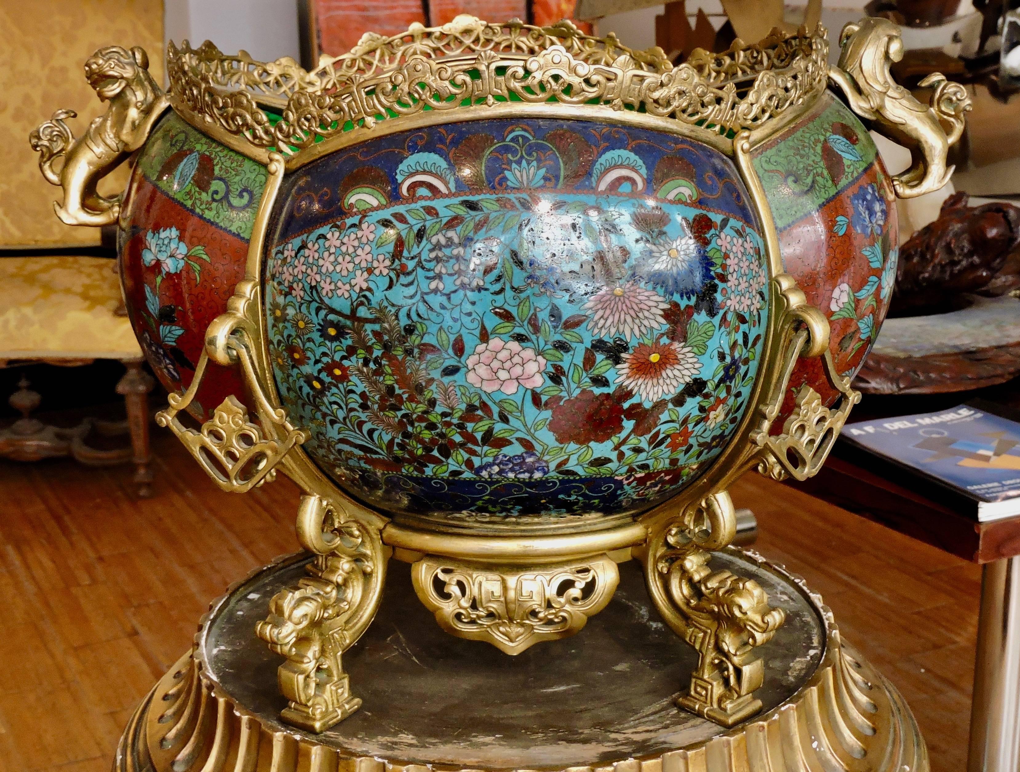 A large French 19th century ormolu and polychromed cloisonné enamel Japonisme lobed cache-pot
chiselled and gilt bronze monture with two chimeras motifs in engagement, four mobile openwork elements, resting on chimera's muffle feet
With original