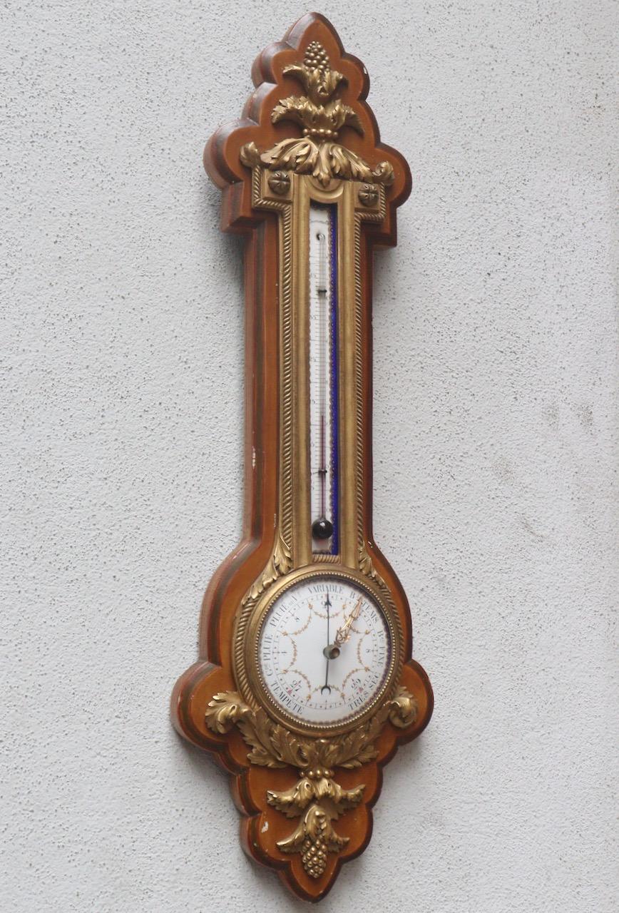 A French 19th Century barometer and thermometer by Eugène Hazart
The shaped foliate case mounted on a wood backboard, the upper part with enameled centi-grade scale thermometer, above a circular barometric polychromed porcelain enameled dial 
The