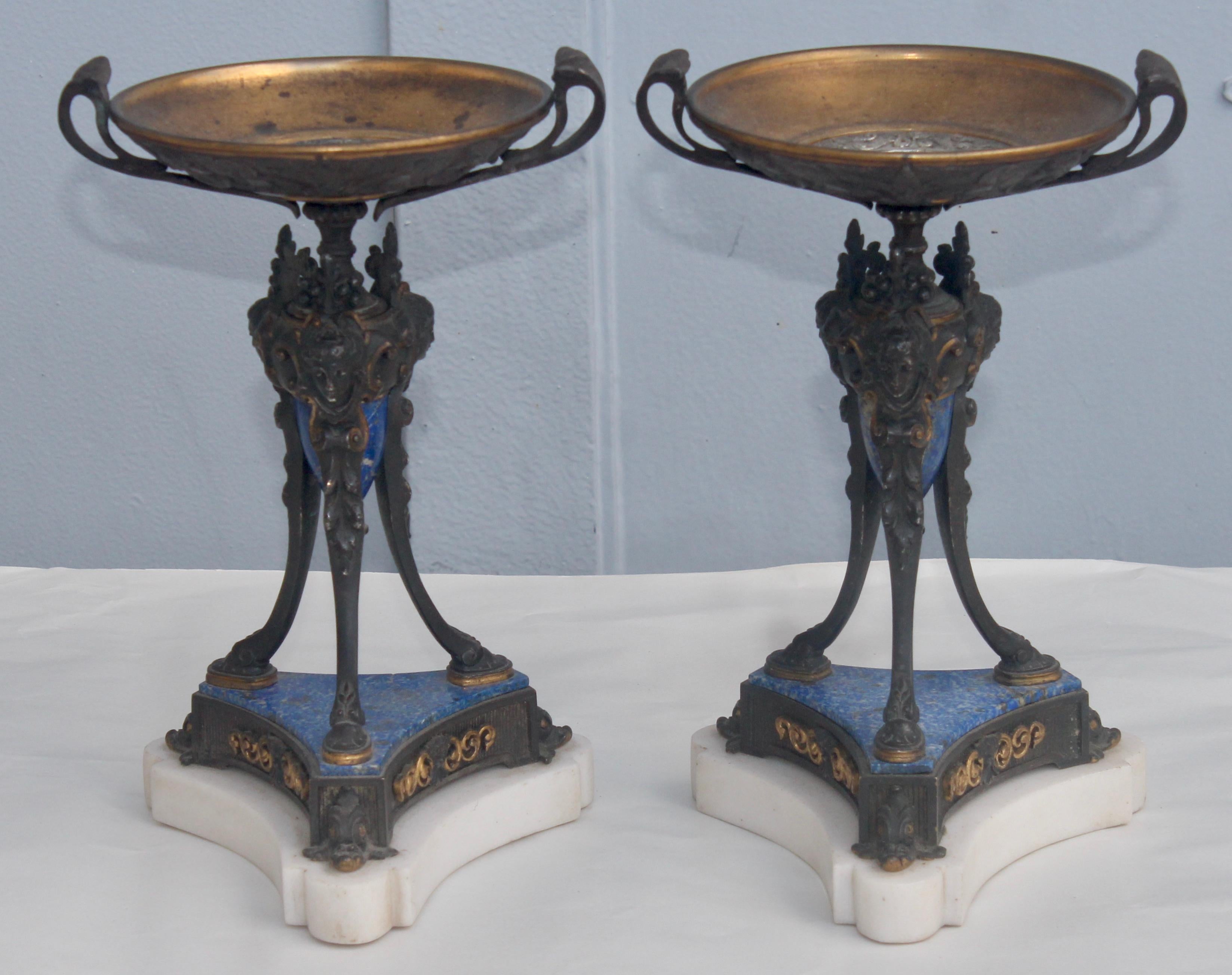 A French 19th century pair of neoclassical tripod tazzas
Ormolu, patinated bronze and Lapis-lazuli on a white marble base
circa 1860.