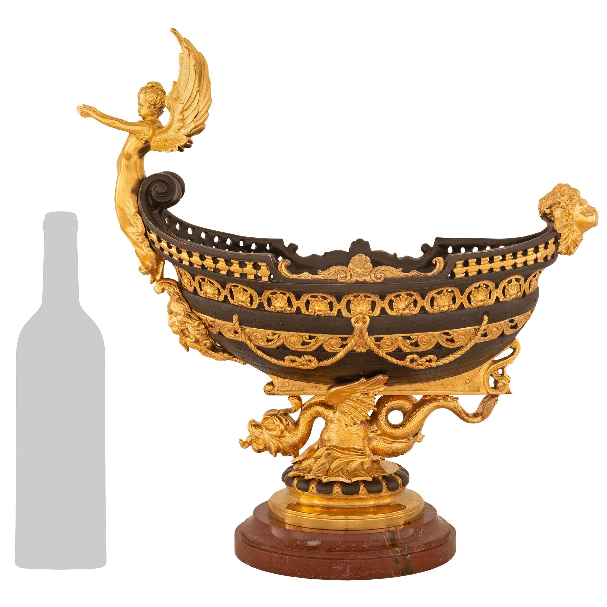 








A striking French 19th century Renaissance st. Patinated Bronze, Ormolu and marble centerpiece possibly by Barbedienne. The centerpiece is raised on an oval marble mottled base below the Ormolu support with patinated cabochons and a