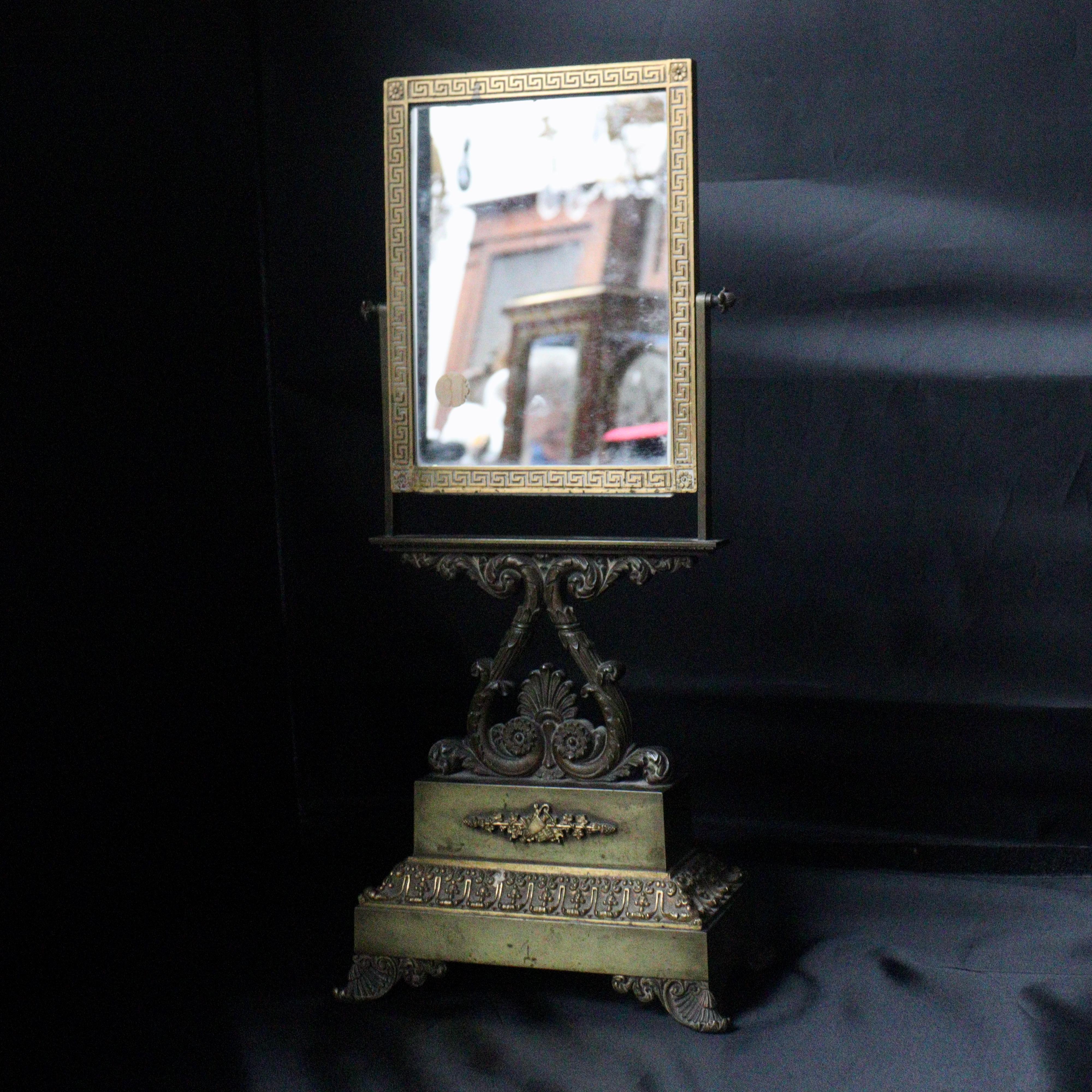 A French 19th Century Restauration Psyche Coiffeuse mirror

Patinated and gilt bronze rectangular Psyche Coiffeuse Mirror
designed with Greek frieze, palmettes, oves, strings of pearls, foliage scrolls and gadroons ormolu mounts
Restauration