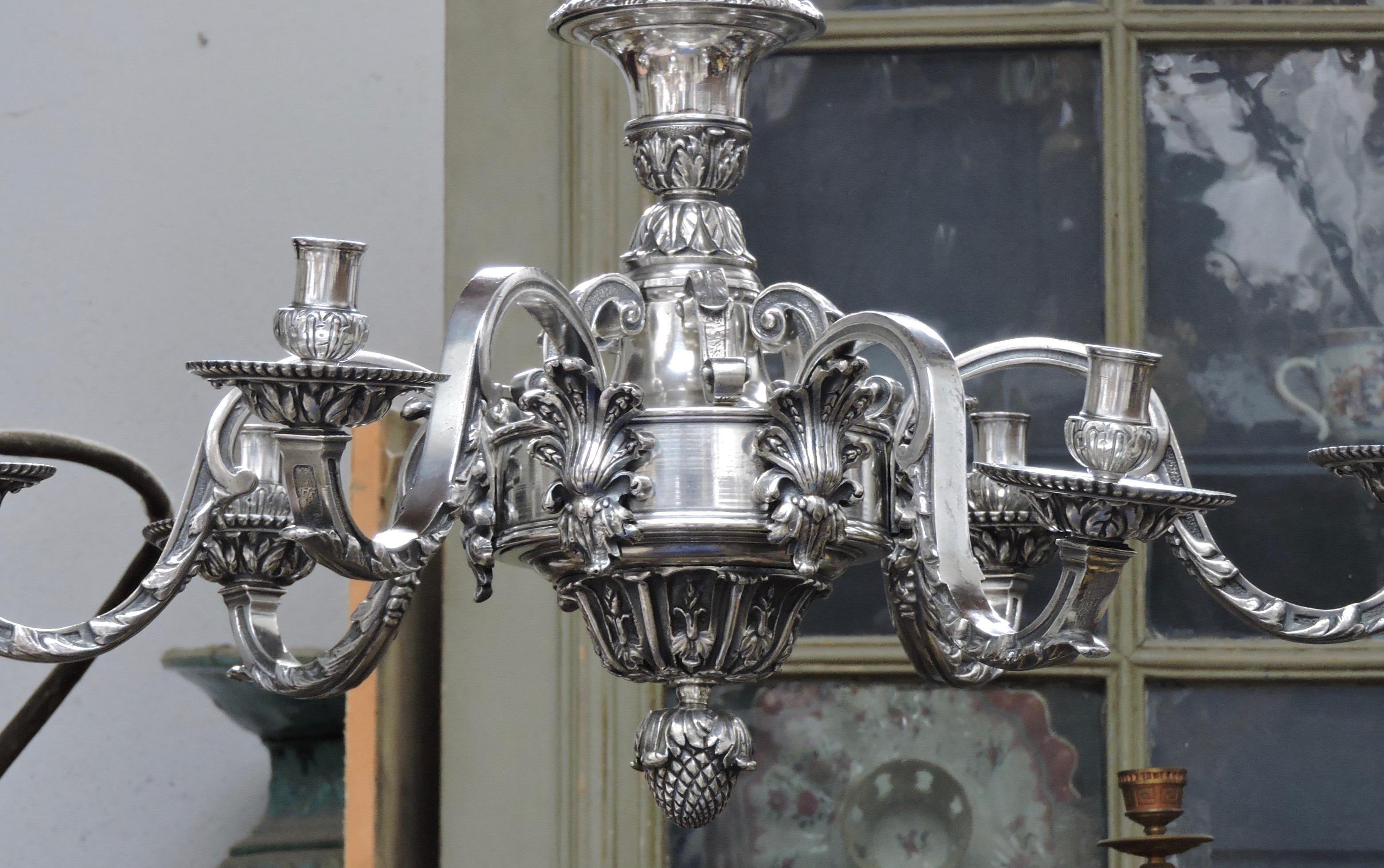 A French 19th century silvered bronze Régence style six-lights chandelier

With fluted and waisted body the lower part with six scrolling branches terminating with circular candle-holders, with pomegranate lower terminal,

circa 1880.