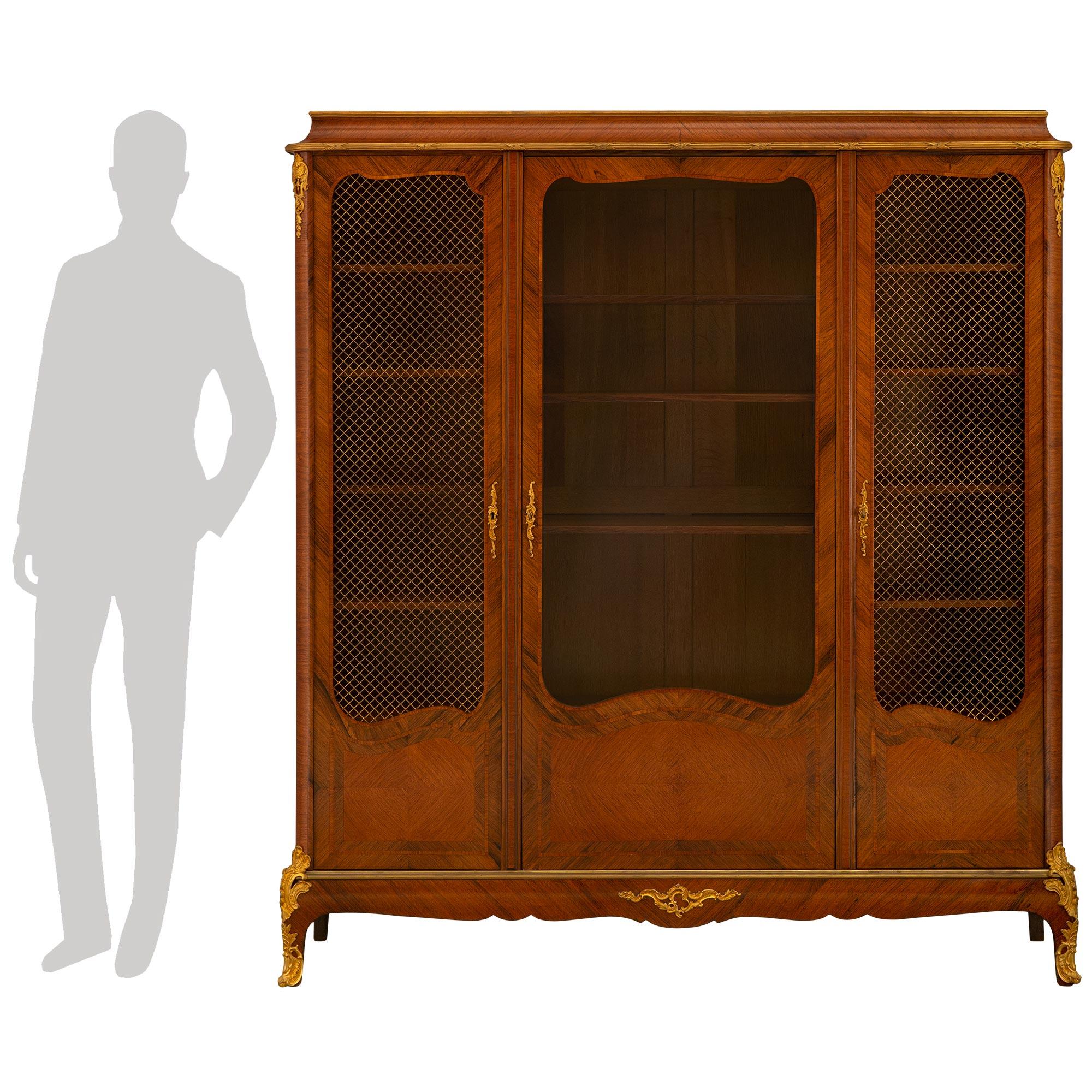 A handsome French 19th century Transitional st. Tulipwood and Ormolu cabinet vitrine.