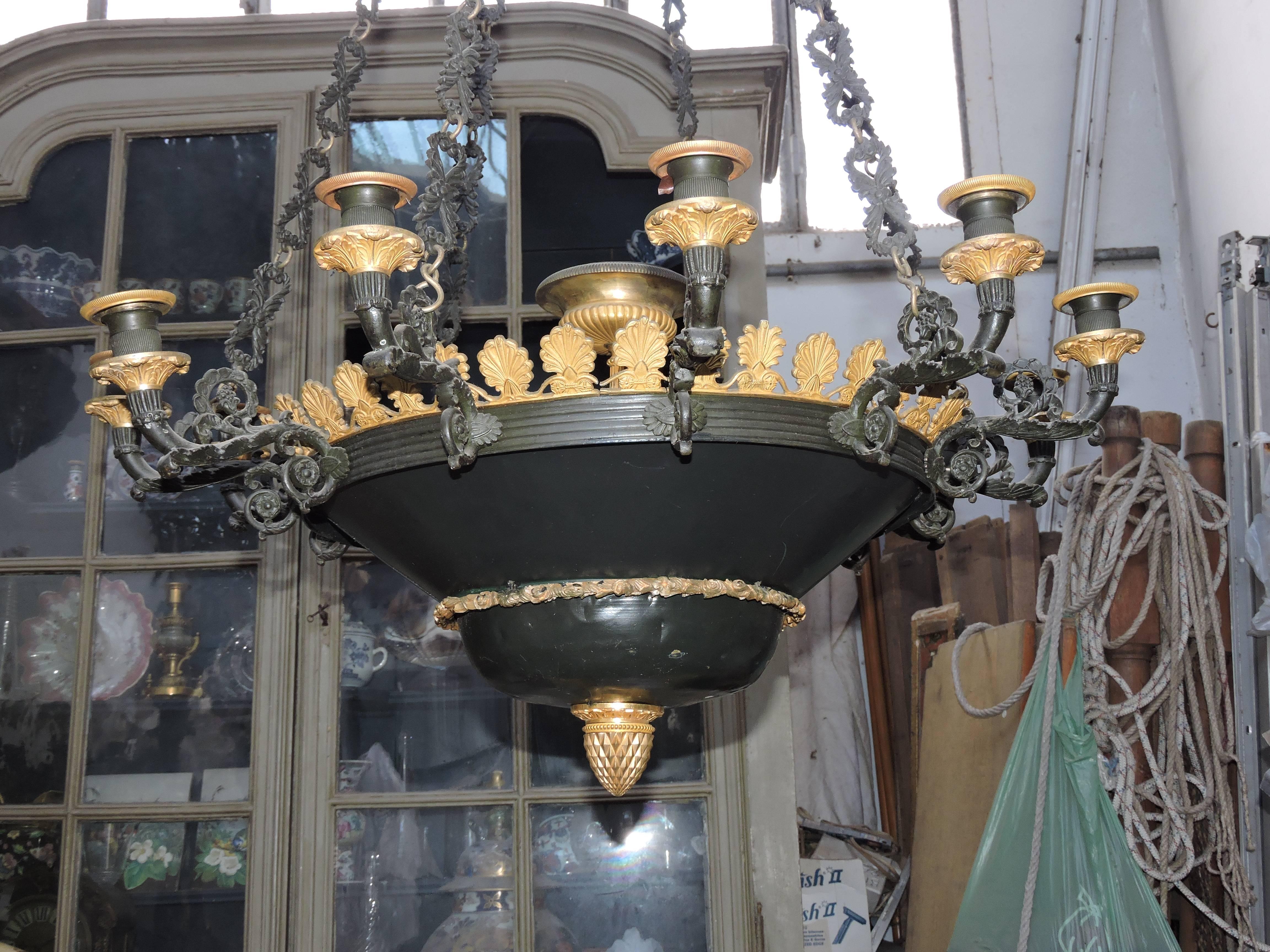 A twelve lights green patinated metal, bronze and ormolu restauration period chandelier.