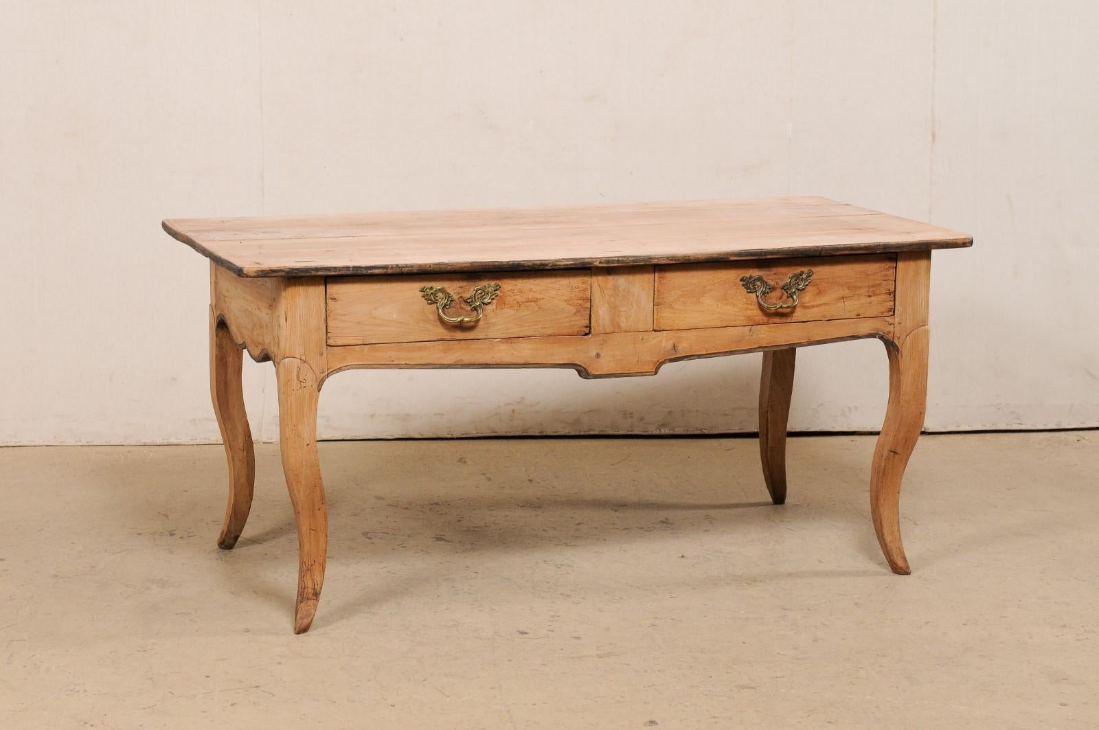 A French bleached wood large console table with two drawers from the 19th century. This antique table from France features a rectangular-shaped top which rests atop an apron which houses a pair of drawers at one long side, and is presented upon