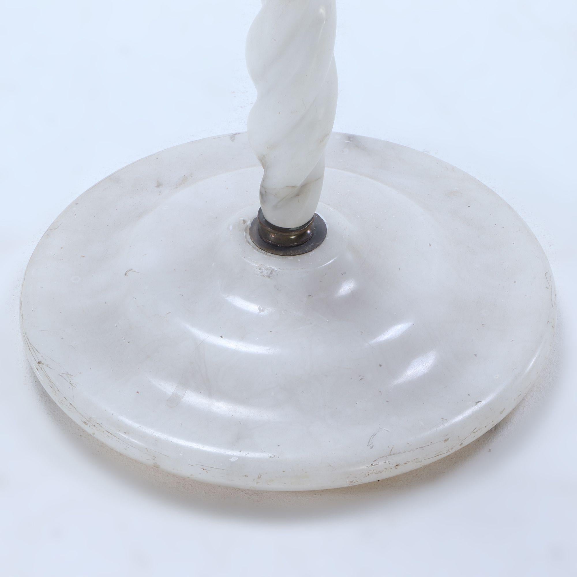 The three-light lamp having a single central shade flanked by two exposed sockets, supported by six sections of twisted alabaster, all over a circular alabaster base,

This item is not located at our Philadelphia gallery and is available at zip code