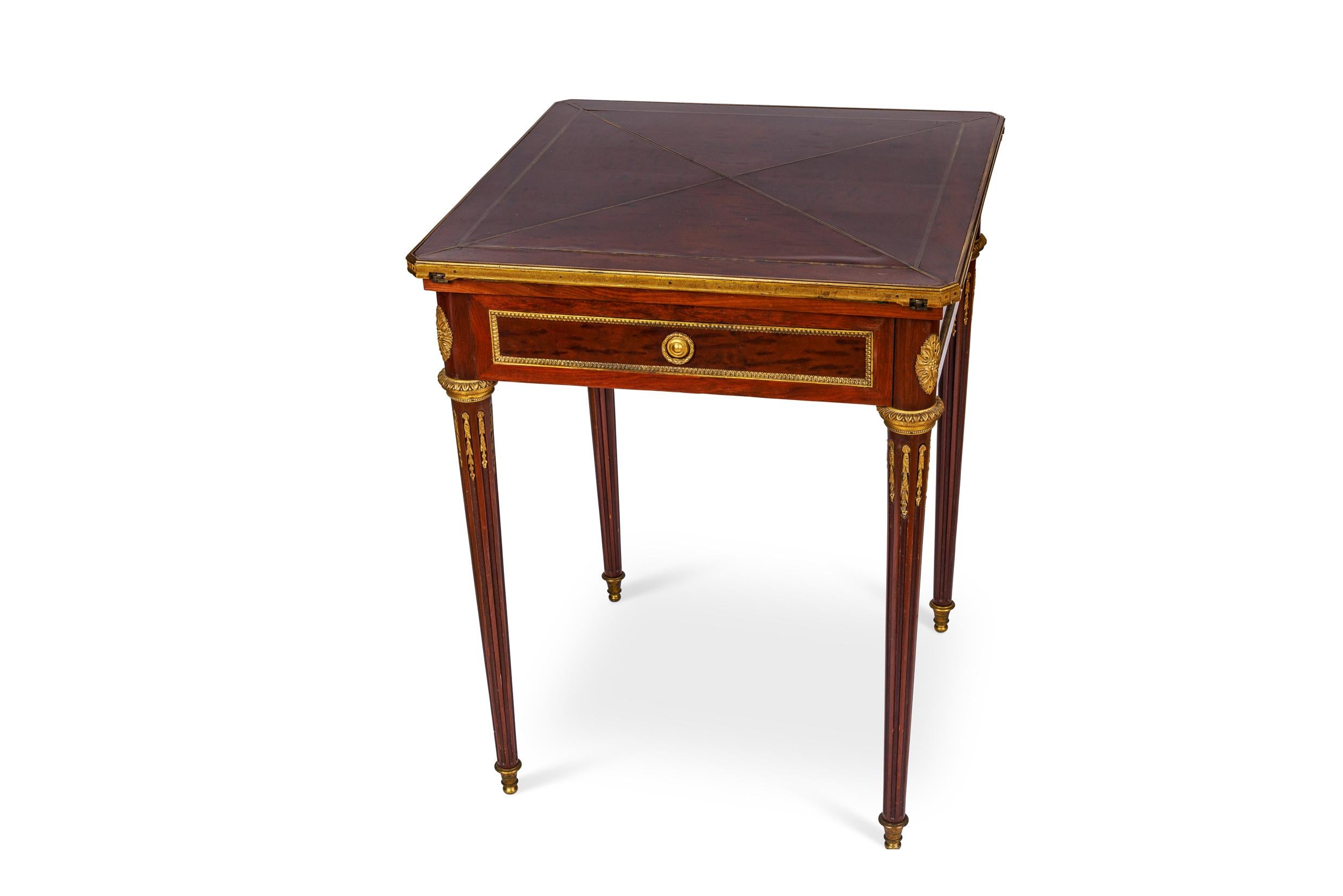 A French Antique Ormolu-Mounted mahogany envelope games card table, C. 1870, attributed to Henry Dasson. 

A very elegant and high quality, French Louis XVI style, mahogany and bronze mounted games table - perfect for playing cards. The table is