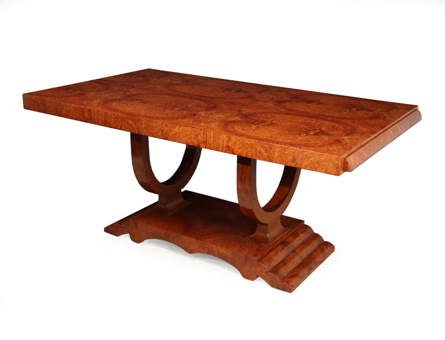 A French Art Deco Amboyna extending dining table, circa 1930

This dining table was produced in France in the 1930s. Standing on a double U base all smothered in the luxurious tight burr of amboyna, the table has two extension leaves so the table