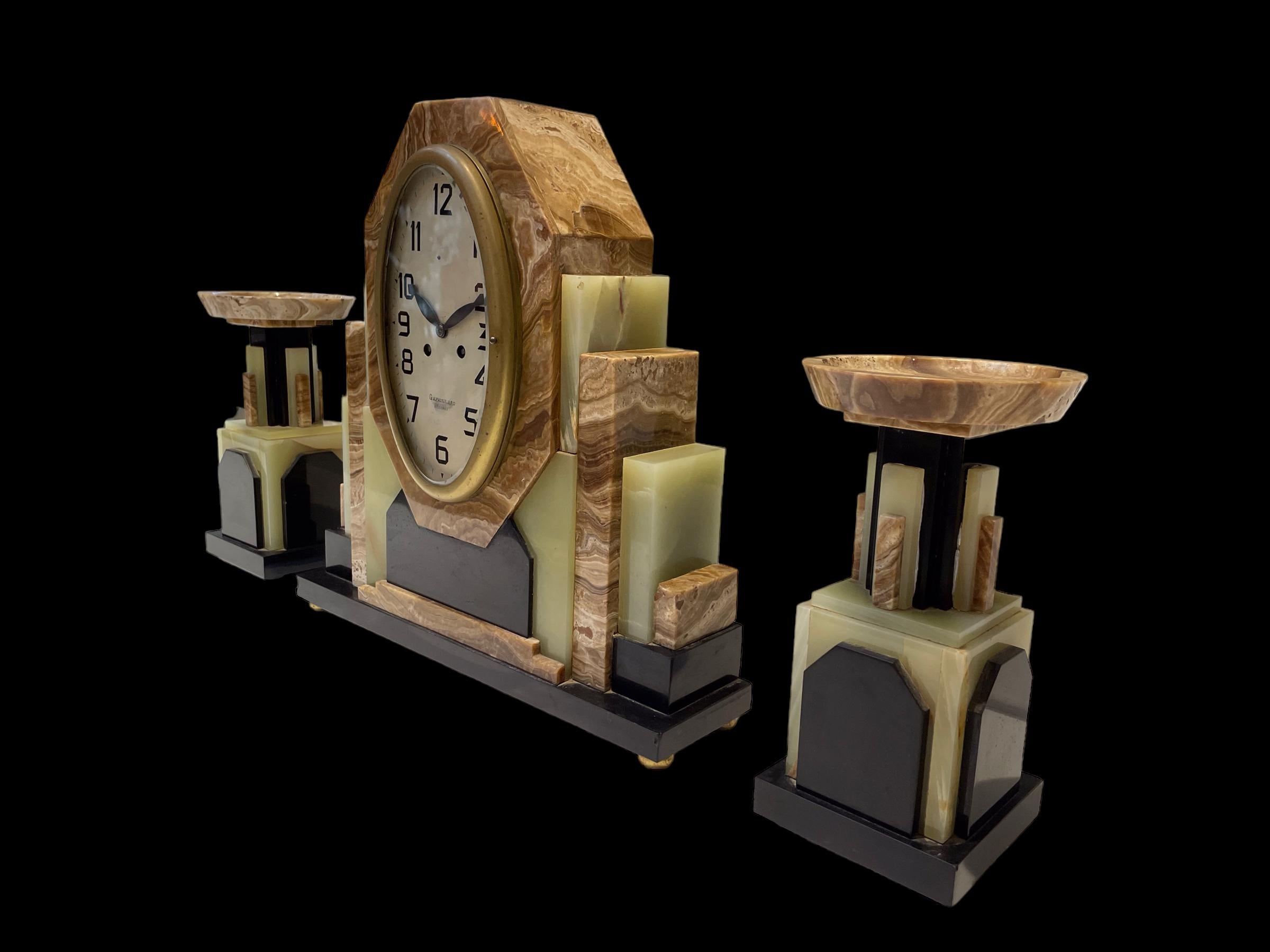 Marble A French Art Deco Clock with its matching pair of Garnitures For Sale