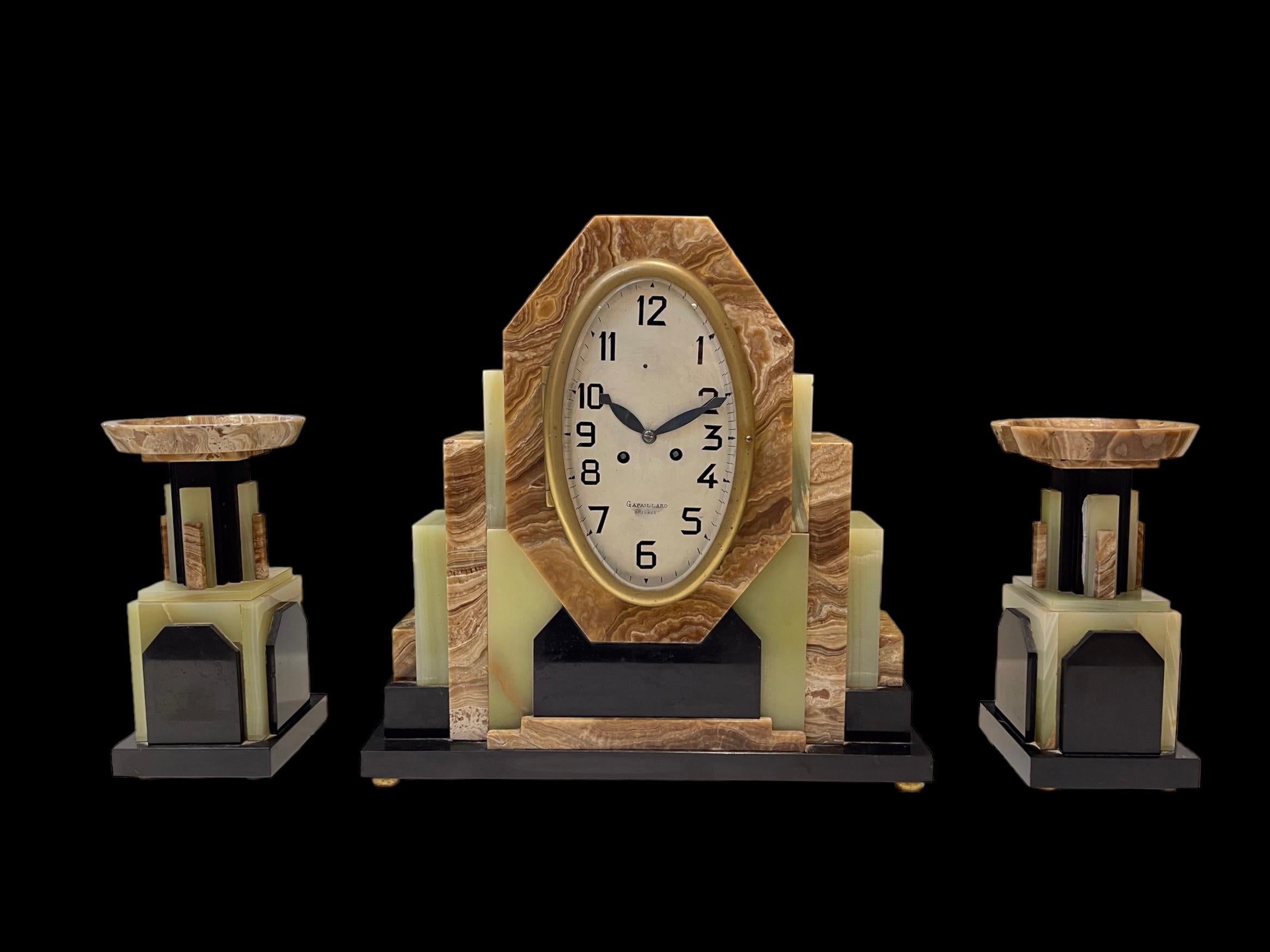 A French Art Deco Clock with its matching pair of Garnitures For Sale 3