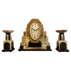 A French Art Deco Clock with its matching pair of Garnitures