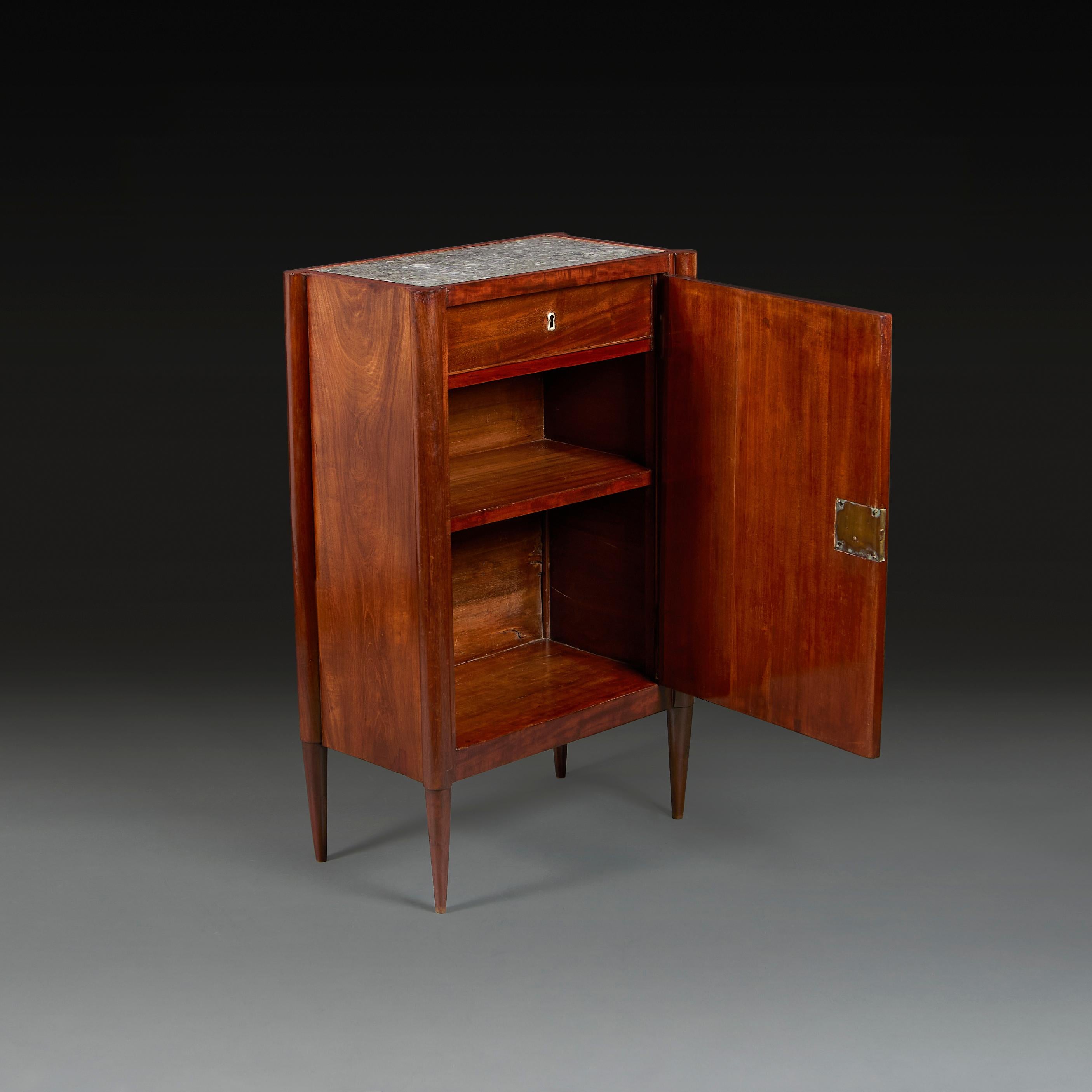 A French Art Deco cocktail cabinet opening with cupboard door to the front, with inset grey stone fossil top, all supported on tapering legs.