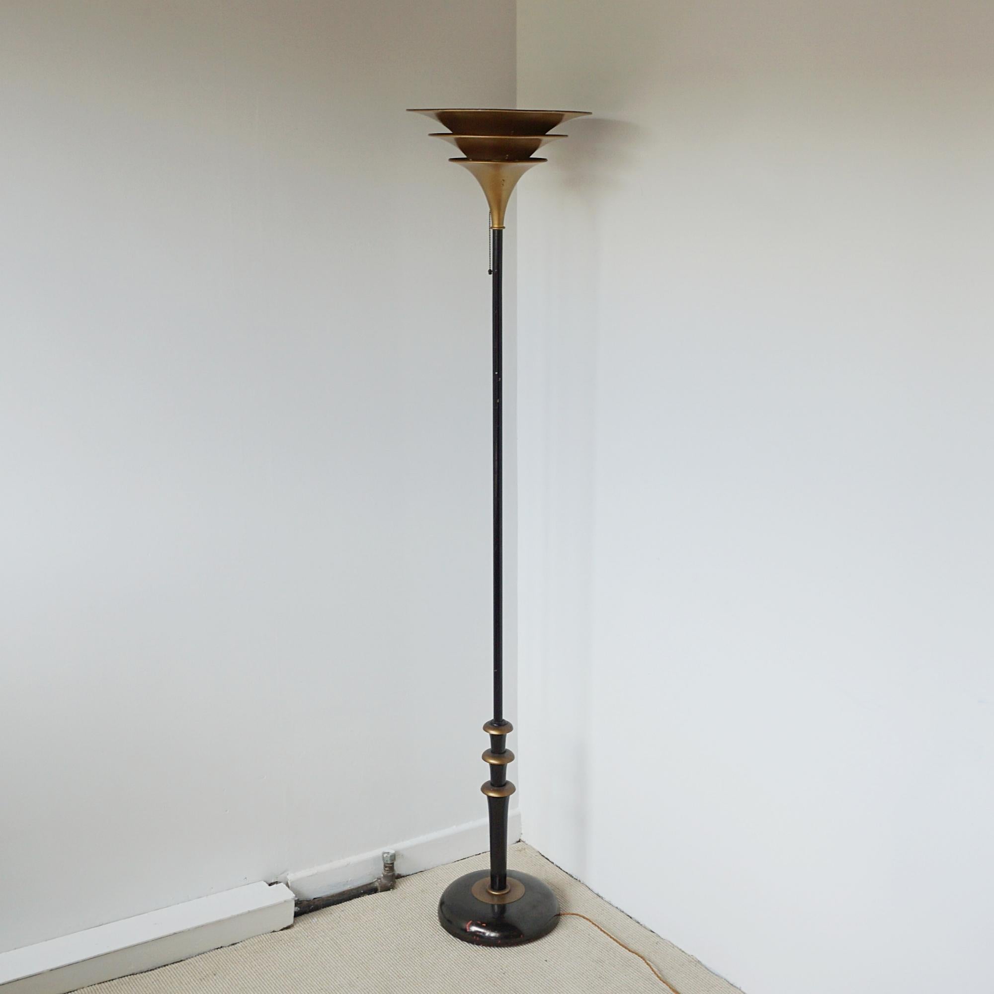A brass and enamel uplighter with roundels to stem and conical graduating brass shade. Scratches to bass in keeping with age and use. 

Dimensions: H 191cm W 40cm 

Origin: French 

Date: Circa 1935

Item Number: 2404243