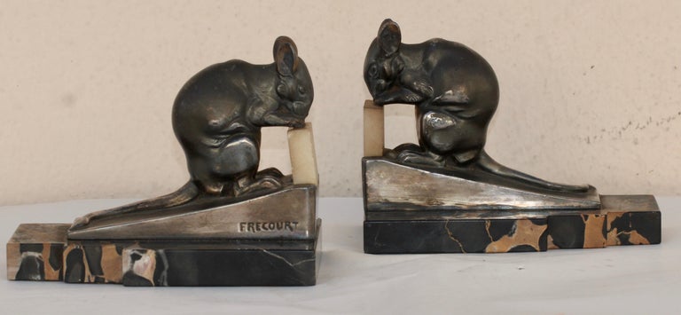 A French Art Deco pair of bookends circa 1930 by Maurice Frecourt (?-1961)
Depicting mouses in silvered bronze nibbling an alabaster piece of cheese
Resting on a Portoro marble base
Both signed Frecourt  

Maurice Frécourt began to practice in 1890,