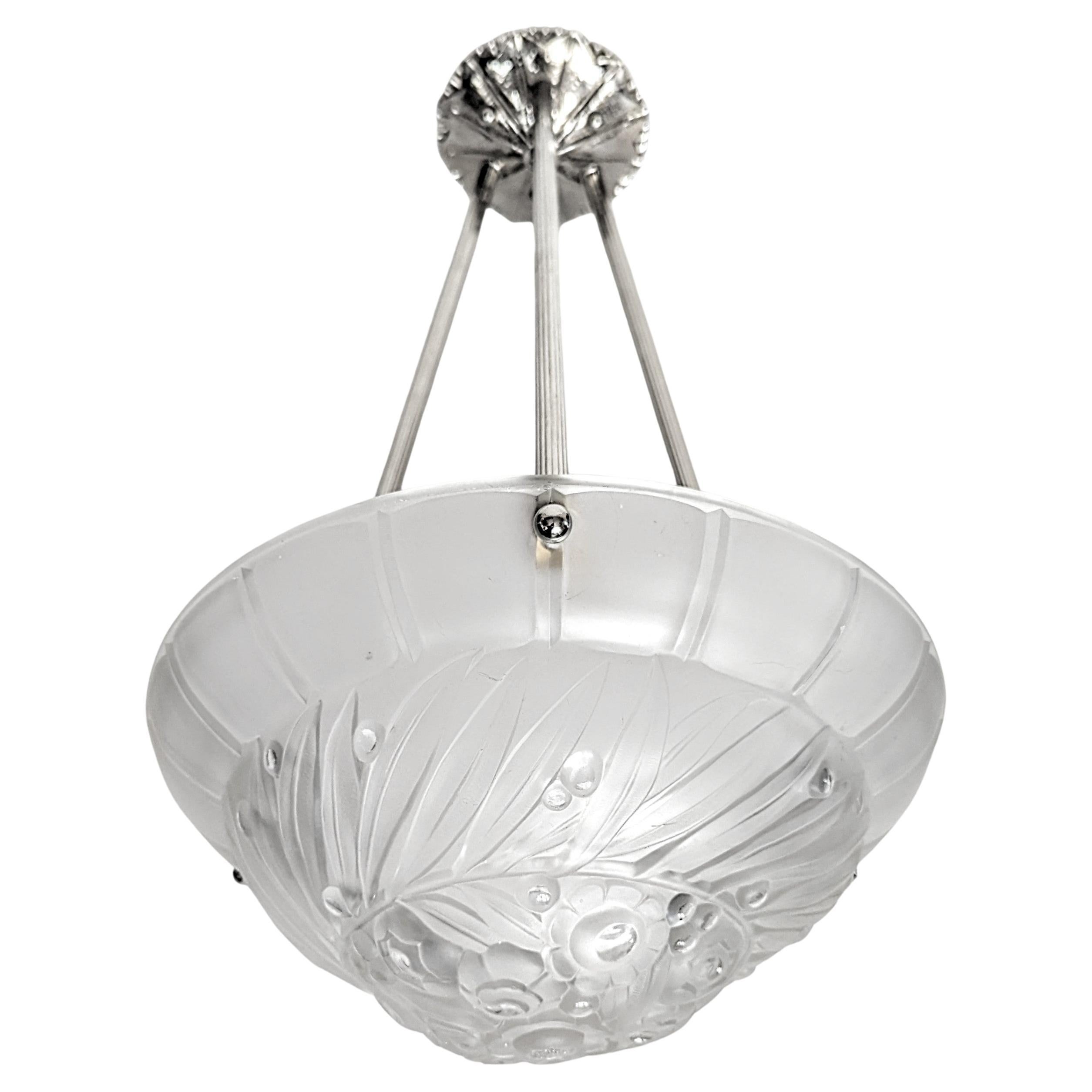 A French Art Deco pendant chandelier in great condition. Clear frosted molded glass shade with intricate flower polished motif details held by three ribbed rods with a matching canopy. The fixture has been re-plated in nickel and rewired for U.S.