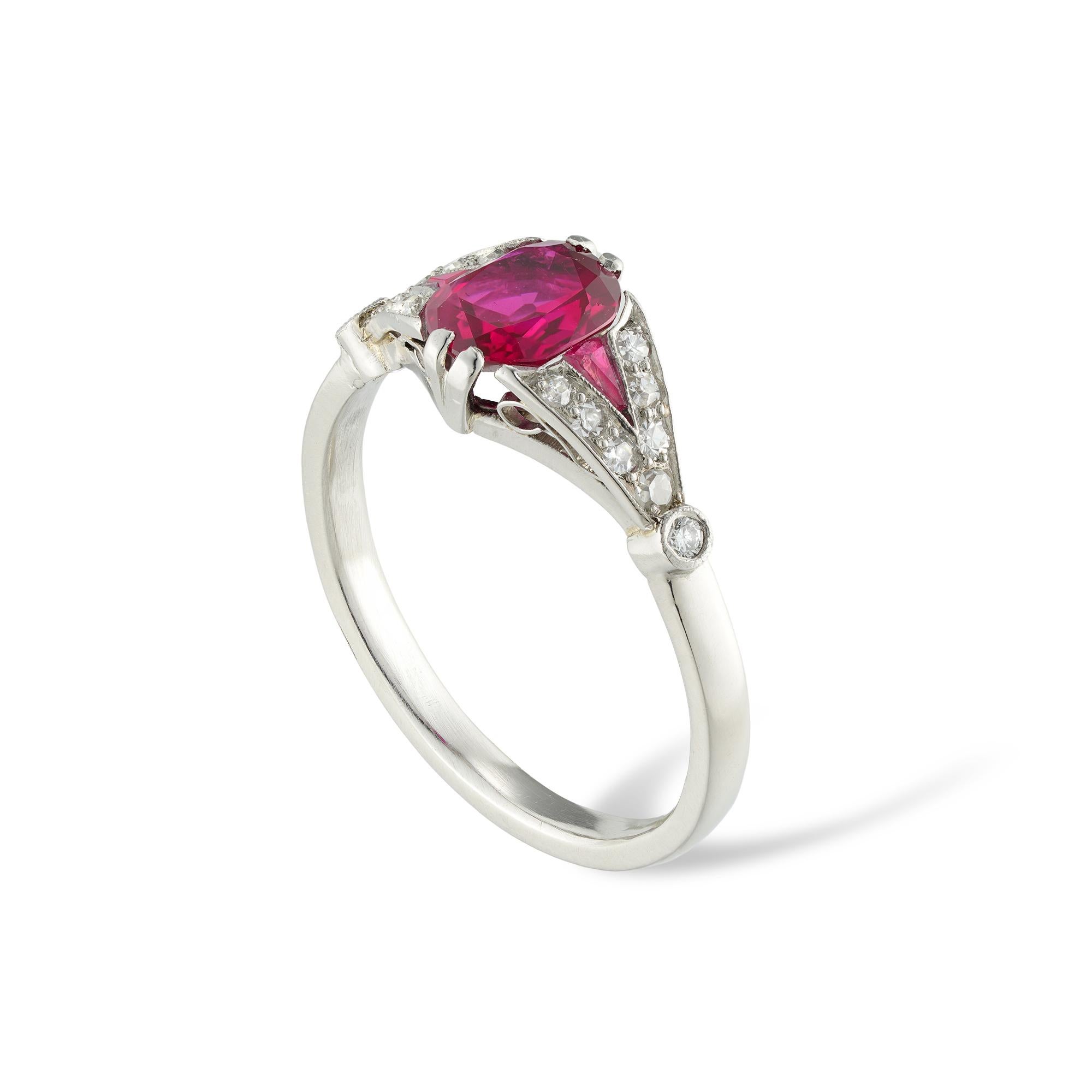 A French Art Deco ruby and diamond ring, the cushion-cut ruby weighing 0.90 carats, accompanied by GCS Report stating to be of Burmese origin with no indication of heating, claw-set between two triangular-cut rubies within a swiss-cut diamond-set