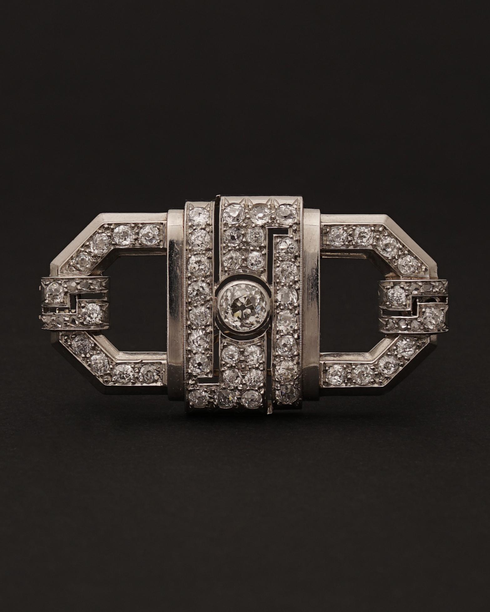 Beautiful French Art Deco 18ct White Gold and Diamond Brooch, C. 1930
Of Geometric asymmetric design, set with a center Old Round Cut Diamond (I/L - I2) and 48 diamonds for a total of 5,76 cts.
Numbered, Maker's mark partially erased (see