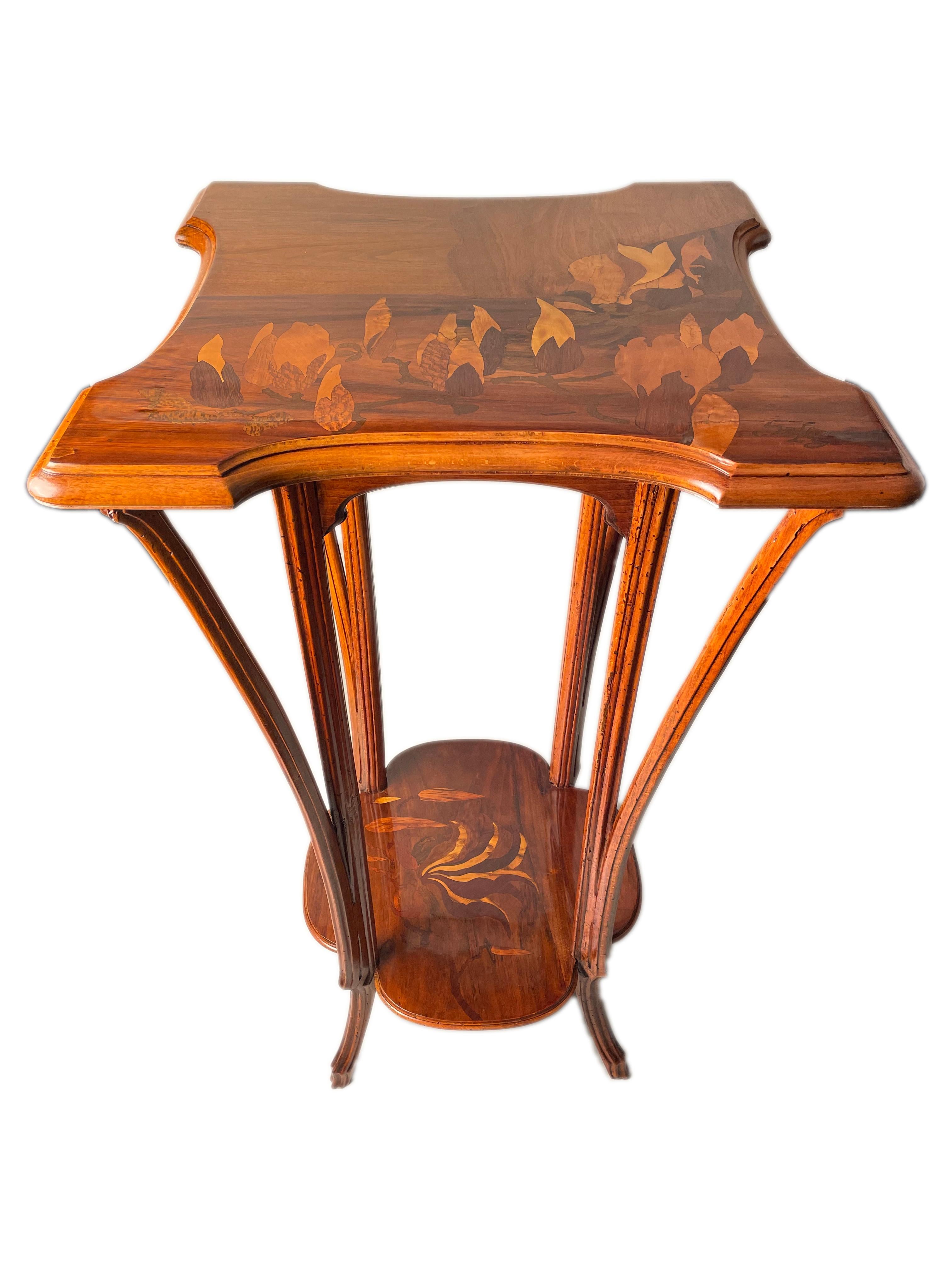 An early 20th century French Art Nouveau carved fruitwood & marquetry pedestal by, Emile Gallé featuring inlaid fruitwood marquetry depicting magnolias on the upper and a flowering magnolia on the lower with carved legs and further signed in inlay