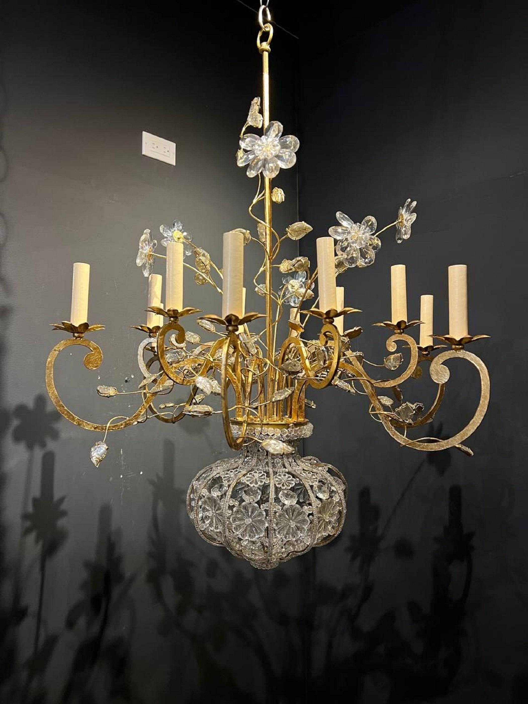 A circa 1930’s French gilt metal and crystal chandelier with 12 lights. Floral design and crystal bottom part.
Dealer: G302YP.